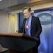Late-night television host and comedian Conan O'Brien stands behind the podium as he tours the Brady Press Briefing room of the White House in Washing