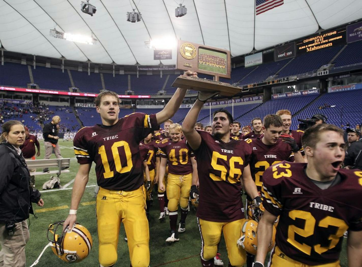 Mahnomen's Jacob Pavek (10) and Nick Otto (56) hold their team's trophy and celebrate their 20-14 1A Prep Bowl championship over Bethlehem Academy at the Metrodome Saturday, Nov. 24, 2012, in Minneapolis, MN. (DAVID JOLES/STARTRIBUNE) djoles@startribune.com Bethlehem Academy and Mahnomen during quarter action at the 1A Prep Bowl championship at the Metrodome Saturday, Nov. 24, 2012, in Minneapolis, MN.**Jacob Pavek, Nick Otto,cq