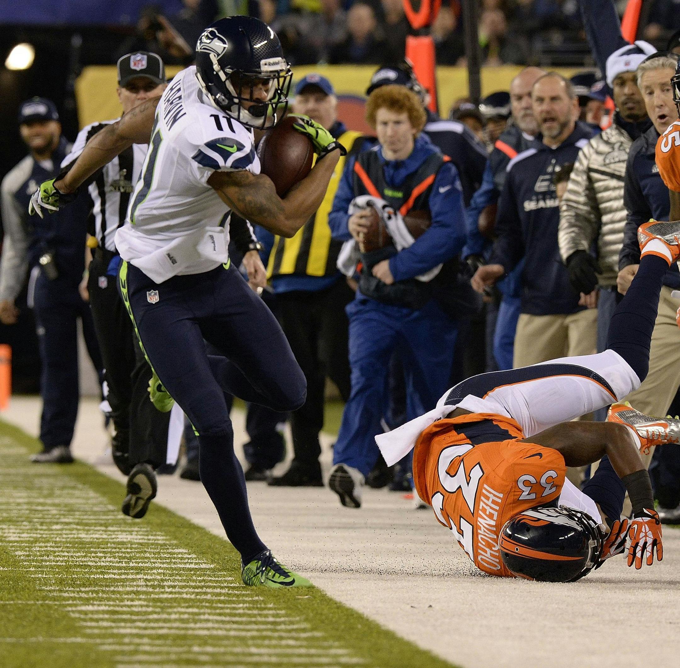 Seattle Seahawks wide receiver Percy Harvin (11) steps out of bounds while running down field against the Denver Broncos' Duke Ihenacho (33) in the first quarter of Super Bowl XLVIII at MetLife Stadium in East Rutherford, N.J., on Sunday, Feb. 2, 2014. (Christian Murdock/Colorado Springs Gazette/MCT)