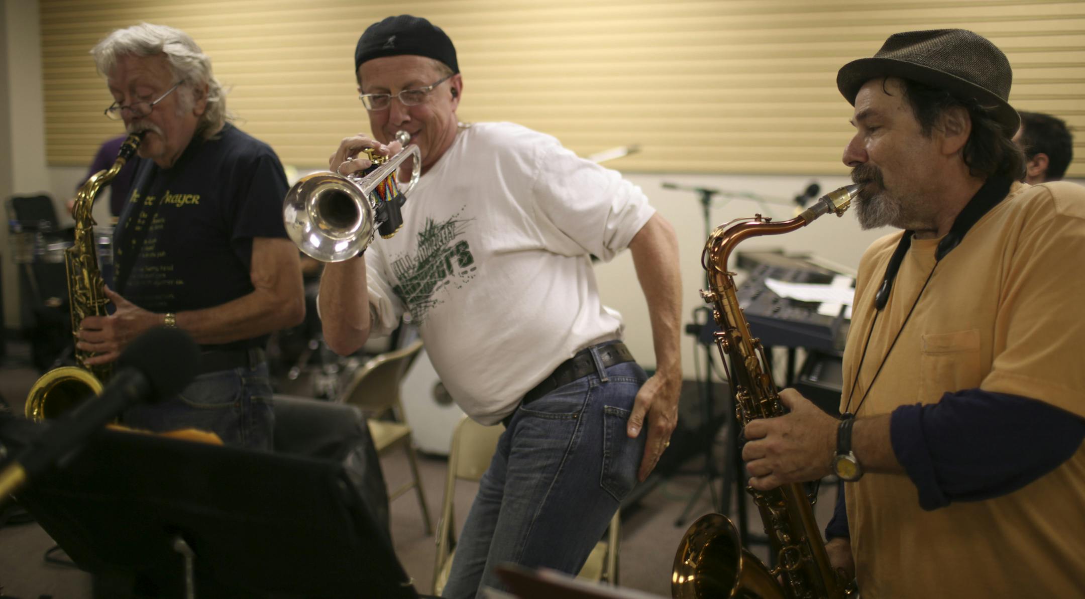 Scott Snyder spanked himself along with the chorus while playing trumpet between Maurice Jacox and Eugene Hoffman Wednesday night. ] JEFF WHEELER • jeff.wheeler@startribune.com Wille and the Bees once were Minnesota's liveliest bar band. The 1970's and 80's heroes are reuniting for a gig at their old stamping ground, The Cabooze. The band rehearsed in an empty storefront in Roseville Wednesday night, October 1, 2014 in preparation for the upcoming show.