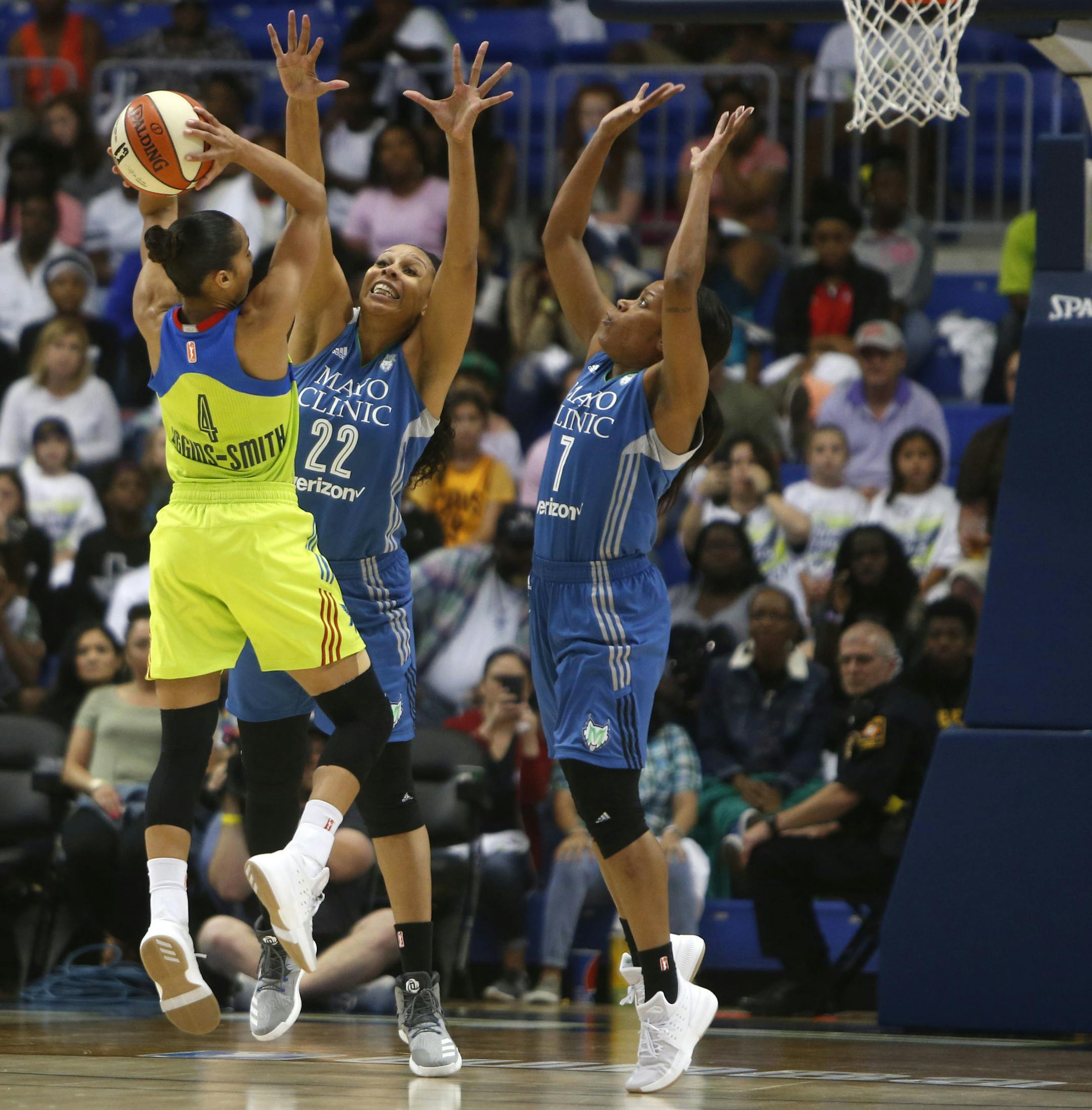 Dallas Wings guard Skylar Diggins (4) lays up a shot against Minnesota Lynx forward Plenette Pierson (22) and guard Jia Perkins (7) in the third quarter of a WNBA basketball game in Arlington, Texas, Saturday, May 20, 2017. (Rose Baca/The Dallas Morning News via AP)