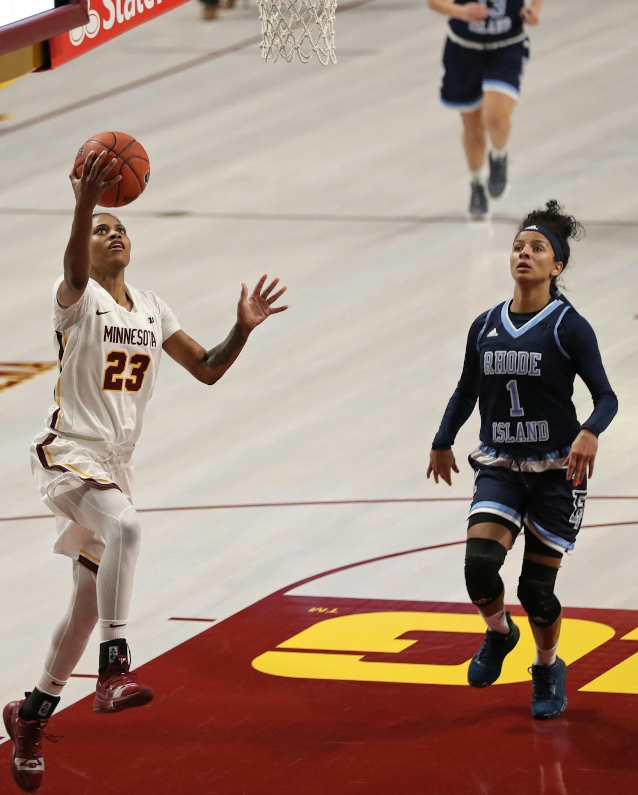 Minnesota Golden Gophers guard Kenisha Bell (23) scored two of her 28 points in the second half as Rhode Island Rams guard Elemy Colome (1) watched.