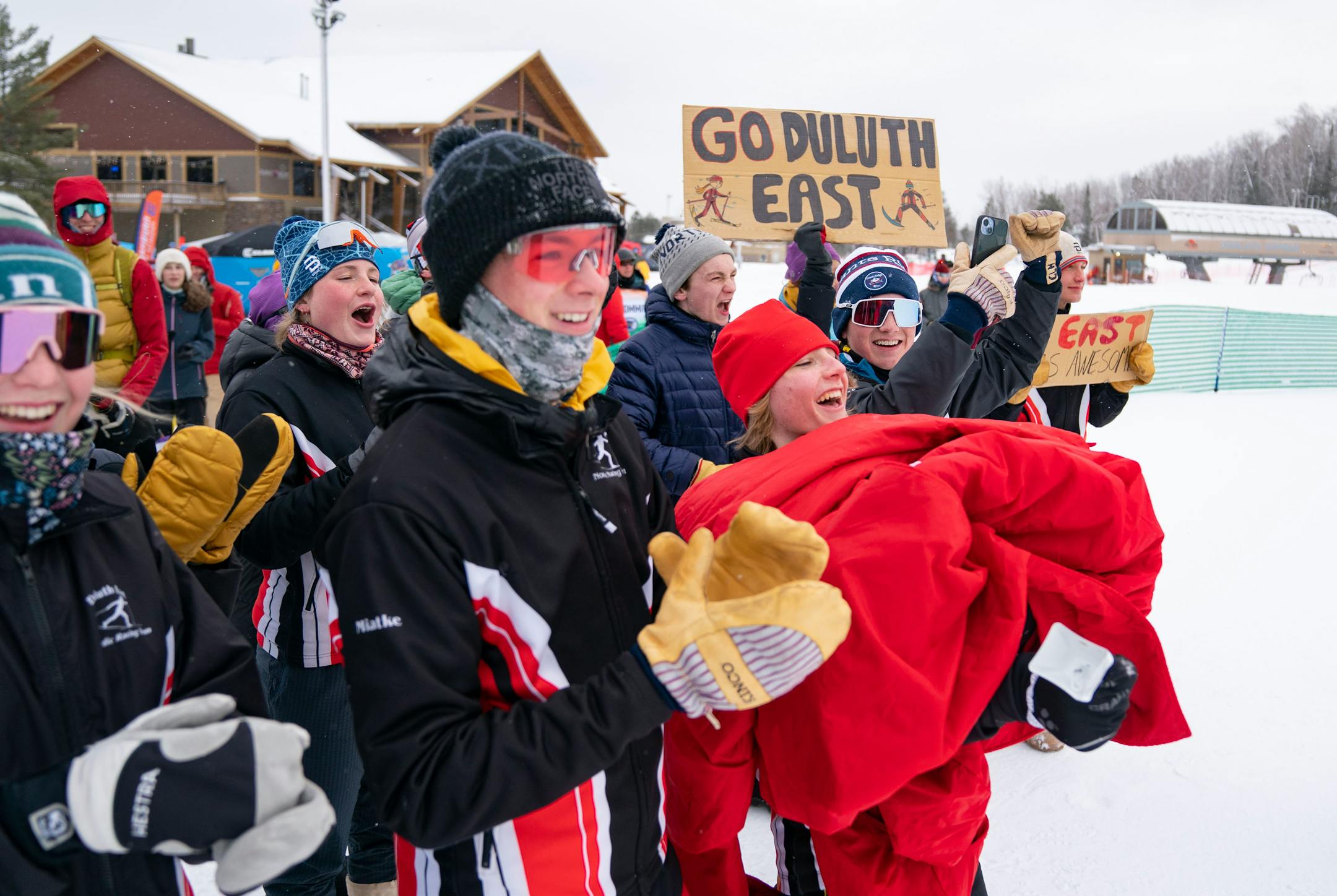 The Duluth East nordic ski team cheers for Colin Willemsen and James Kyes after they took first place in the boy's team sprint final during the MSHSL Boys and Girls Nordic Ski Racing Meet.
