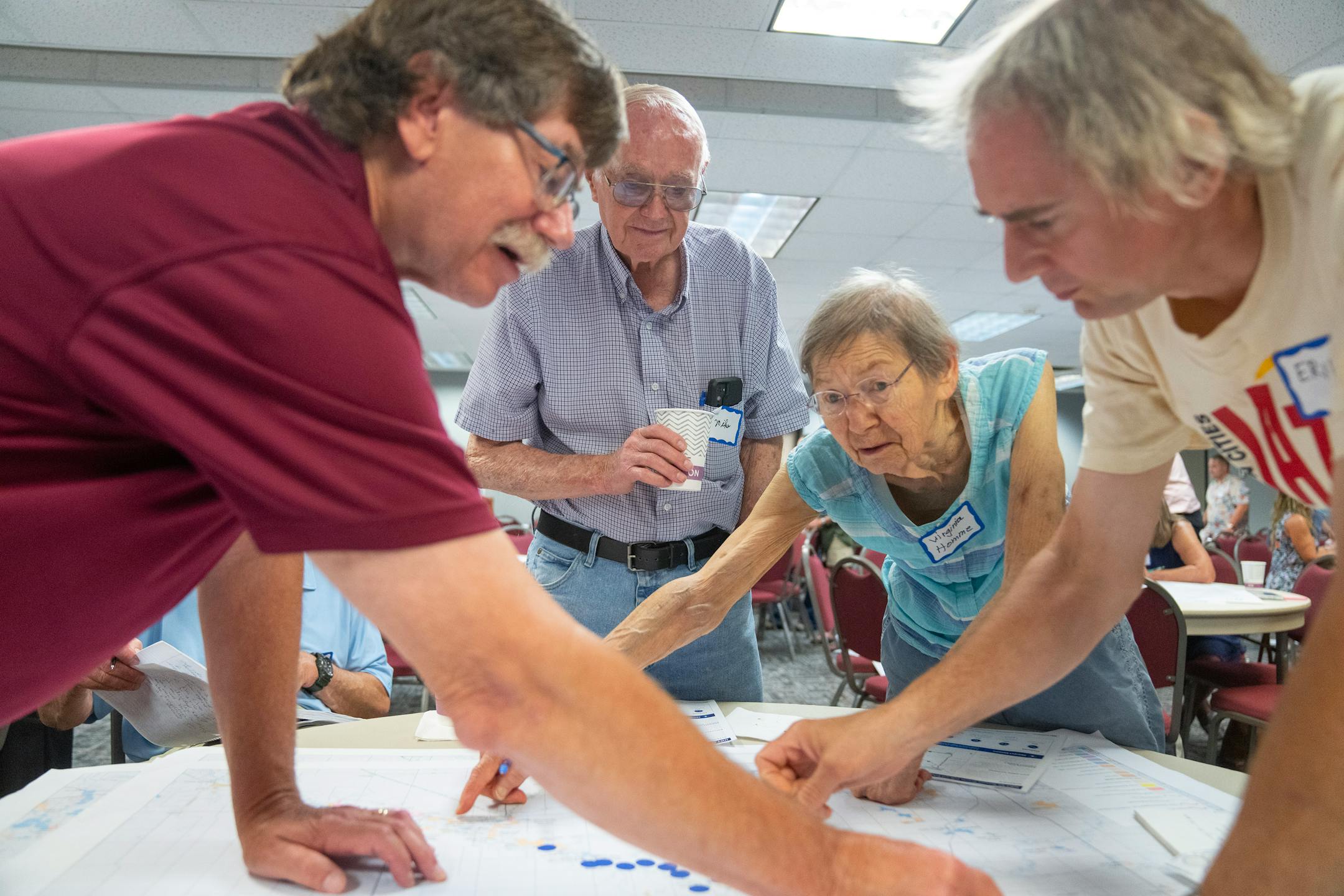 Mayor Dave Smiglewski, Mike, who declined to give his last name, Virginia Homme and Erik Homme, left to right, work on marking a map with areas they like to recreate in the Minnesota River Valley during a DNR public engagement meeting at Kilowatt Community Center.