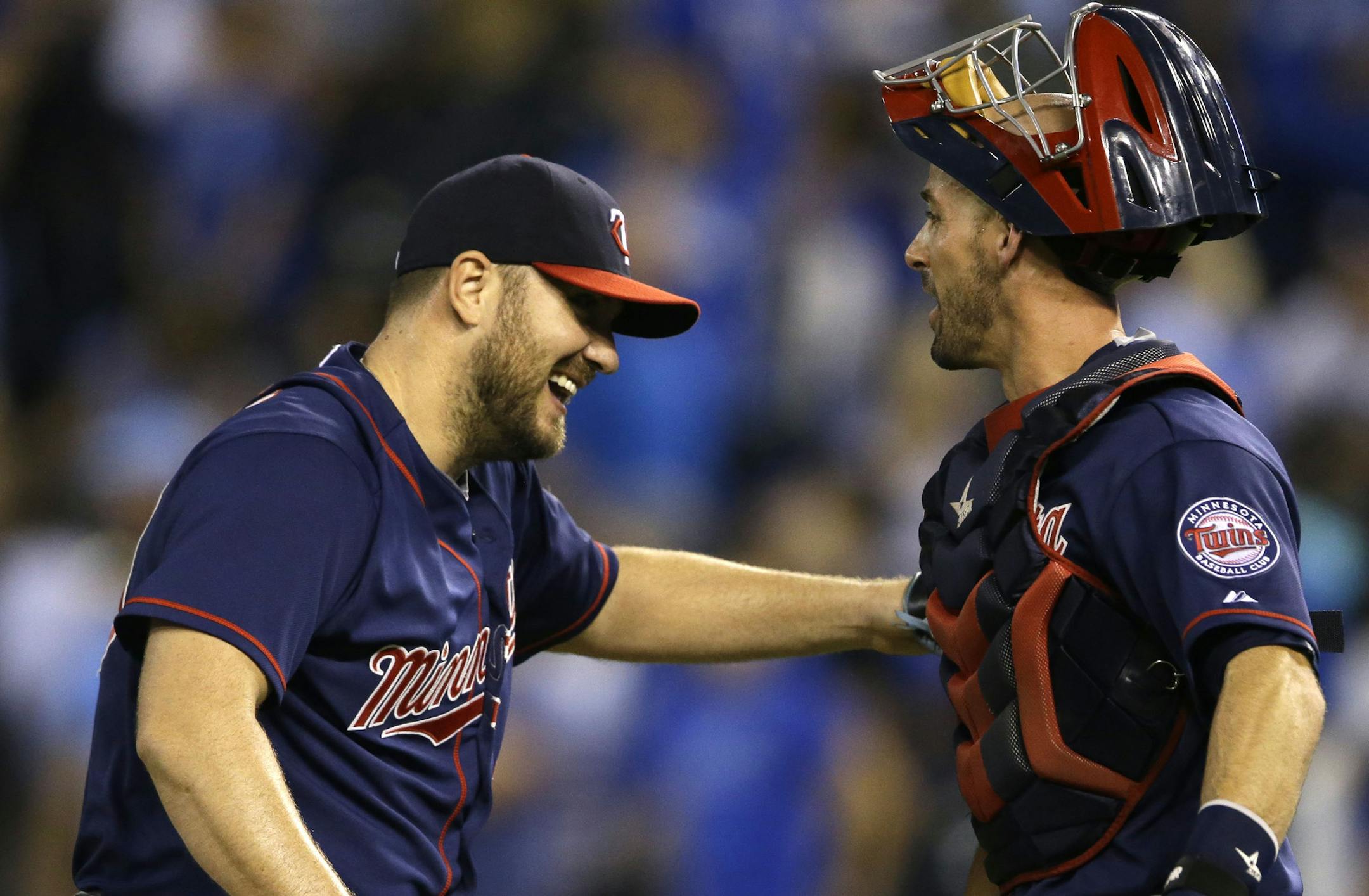 Minnesota Twins relief pitcher Kevin Jepsen, left, celebrates with catcher Chris Herrmann following a baseball game against the Kansas City Royals at Kauffman Stadium in Kansas City, Mo., Wednesday, Sept. 9, 2015. The Twins defeated the Royals 3-2 in 12 innings. (AP Photo/Orlin Wagner)