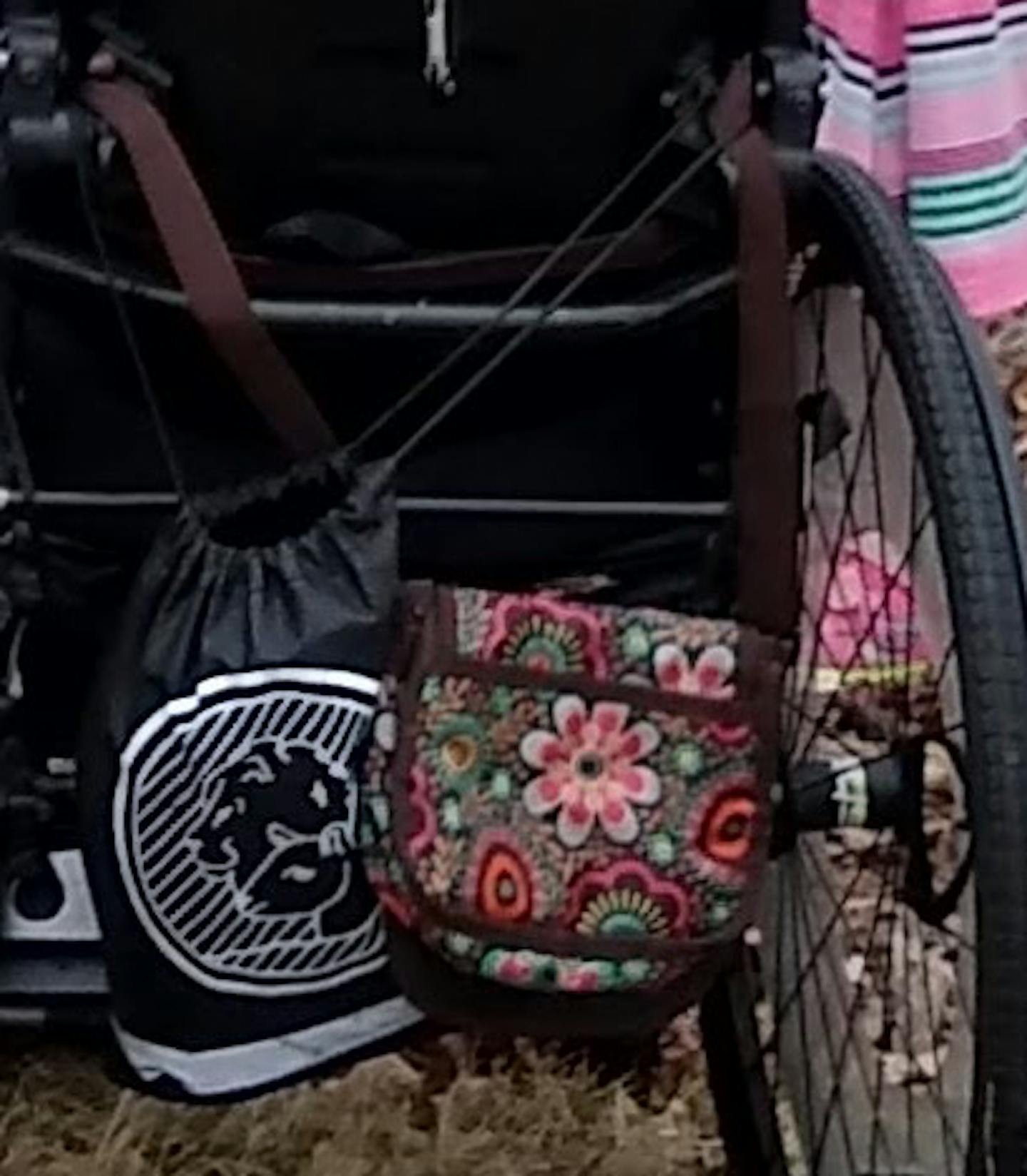 The missing brown floral bag that was on the back of her chair.