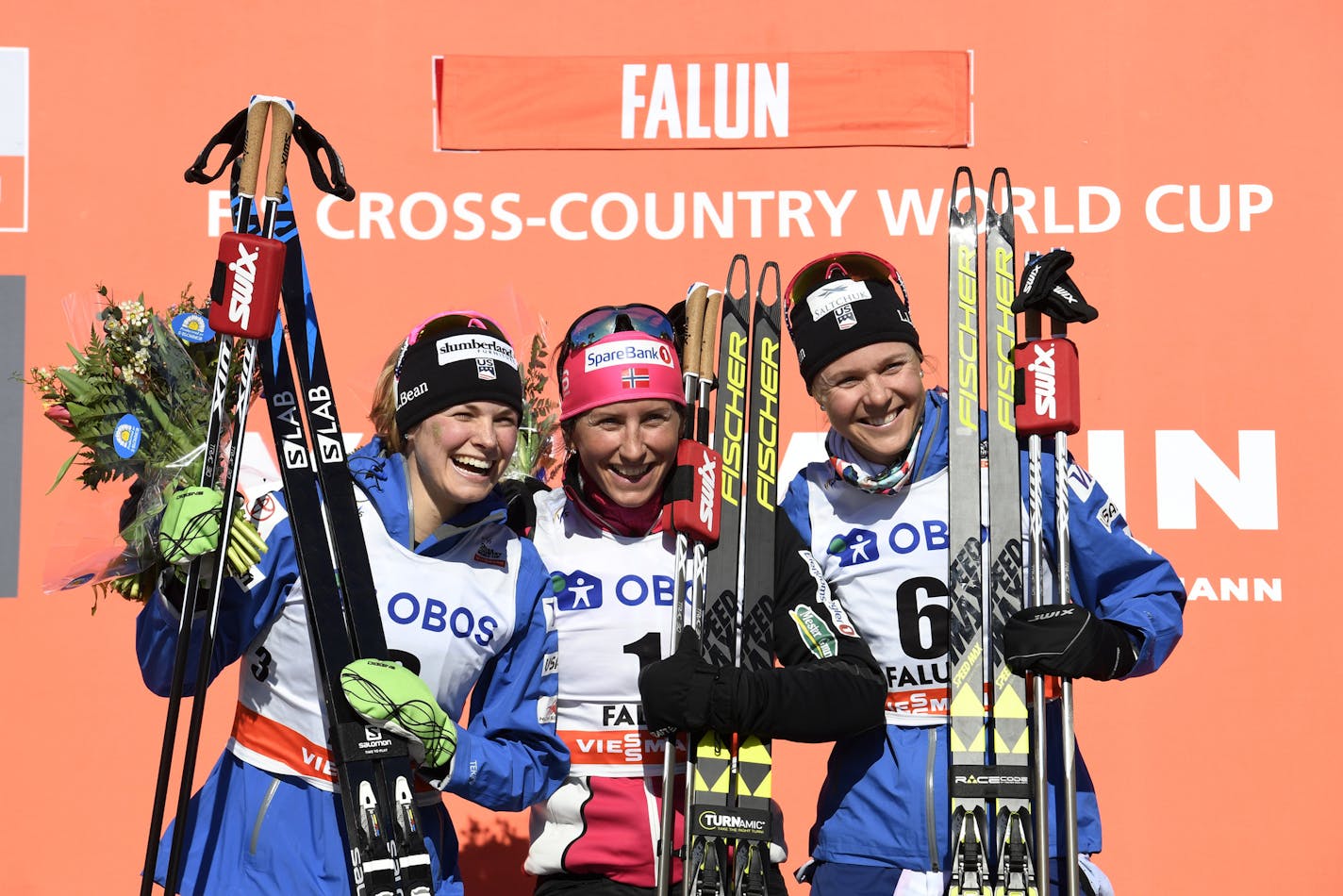 Norway's Marit Bjoergen winner, centre poses for a photographer on the podium with second placed Jessica Diggins of the United States, left and Sadie Bjornsen of the United States at the podium after the 10km cross country free style event of the Cross Country World Cup, in Falun, Sweden, Sunday March 18, 2018. (Ulf Palm /TT News Agency via AP)