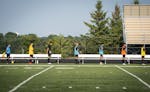 The East Ridge boys soccer team stood for the National Anthem while distanced six feet apart. ] LEILA NAVIDI • leila.navidi@startribune.com BACKGROU