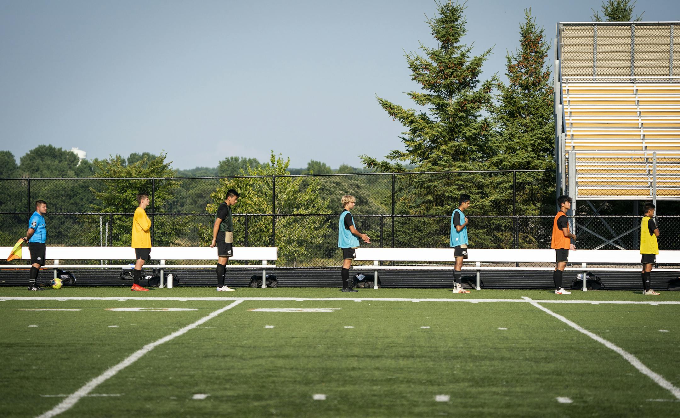 The East Ridge boys soccer team stood for the National Anthem while distanced six feet apart. ] LEILA NAVIDI • leila.navidi@startribune.com BACKGROUND INFORMATION: Mounds View boys soccer plays East Ridge at East Ridge High School in Woodbury on Thursday, August 27, 2020. What is it like to play, coach, officiate and watch prep soccer in the COVID age?