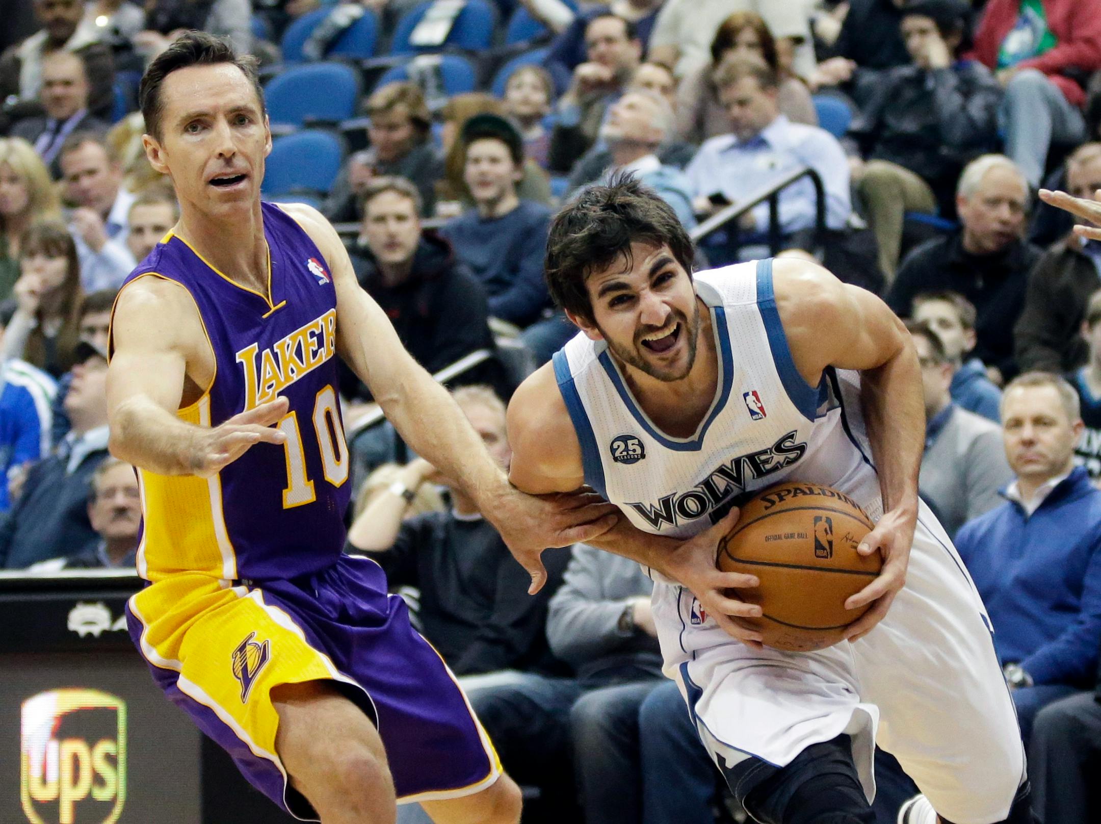 Minnesota Timberwolves' Ricky Rubio, right, of Spain, tries to break away from Los Angeles Lakers' Steve Nash during the first quarter of an NBA basketball game, Tuesday, Feb. 4, 2014, in Minneapolis. (AP Photo/Jim Mone)
