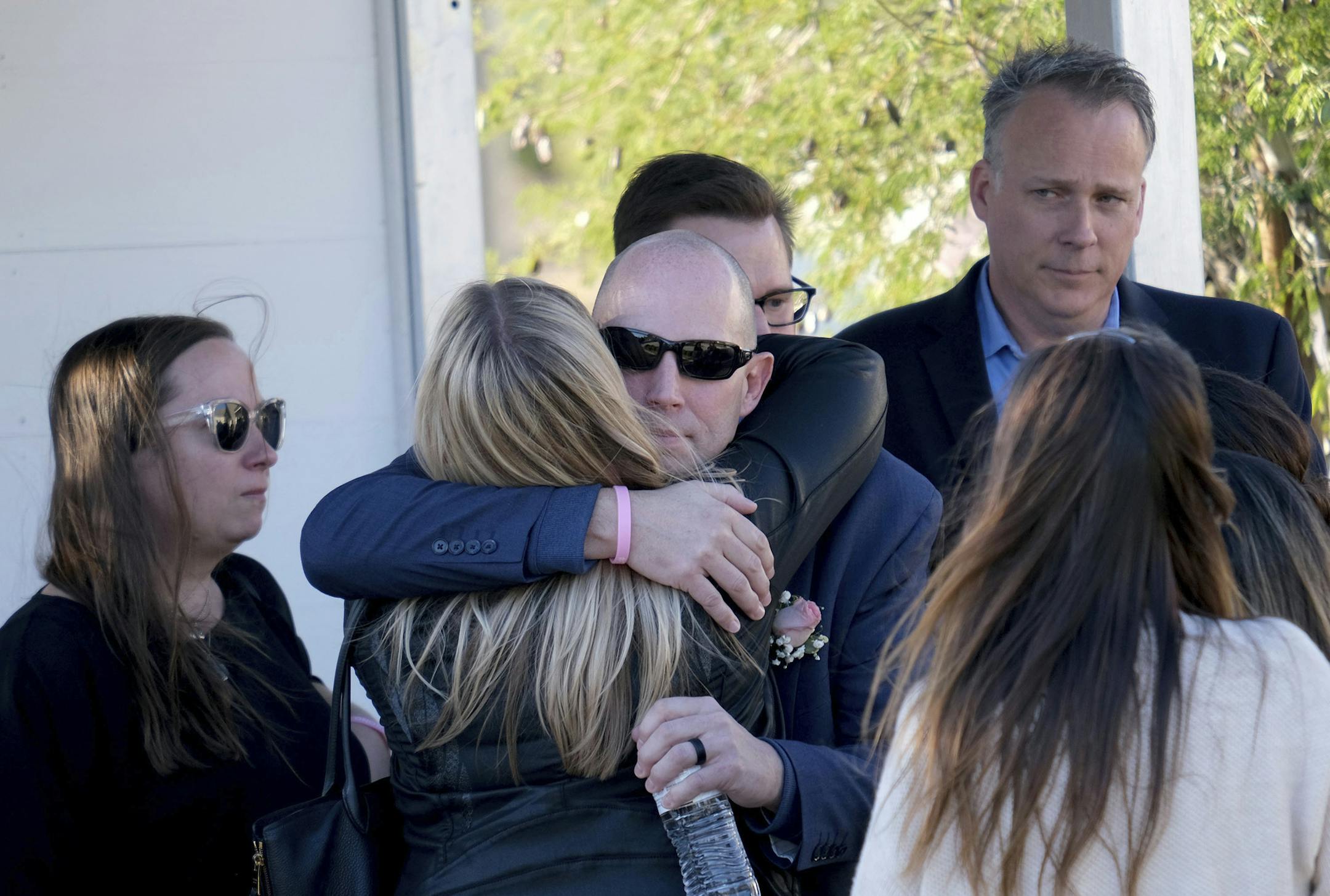 Bryan Muehlberger shares a hug following the memorial service for his daughter, Gracie Anne Muehlberger, 15, at Real Life Church, Saturday, Nov. 23, 2019, in Valencia, Calif. Muehlberger was one of two students killed Nov. 14, 2019, shooting at Saugus High School. (Dean Musgrove/The Orange County Register via AP)