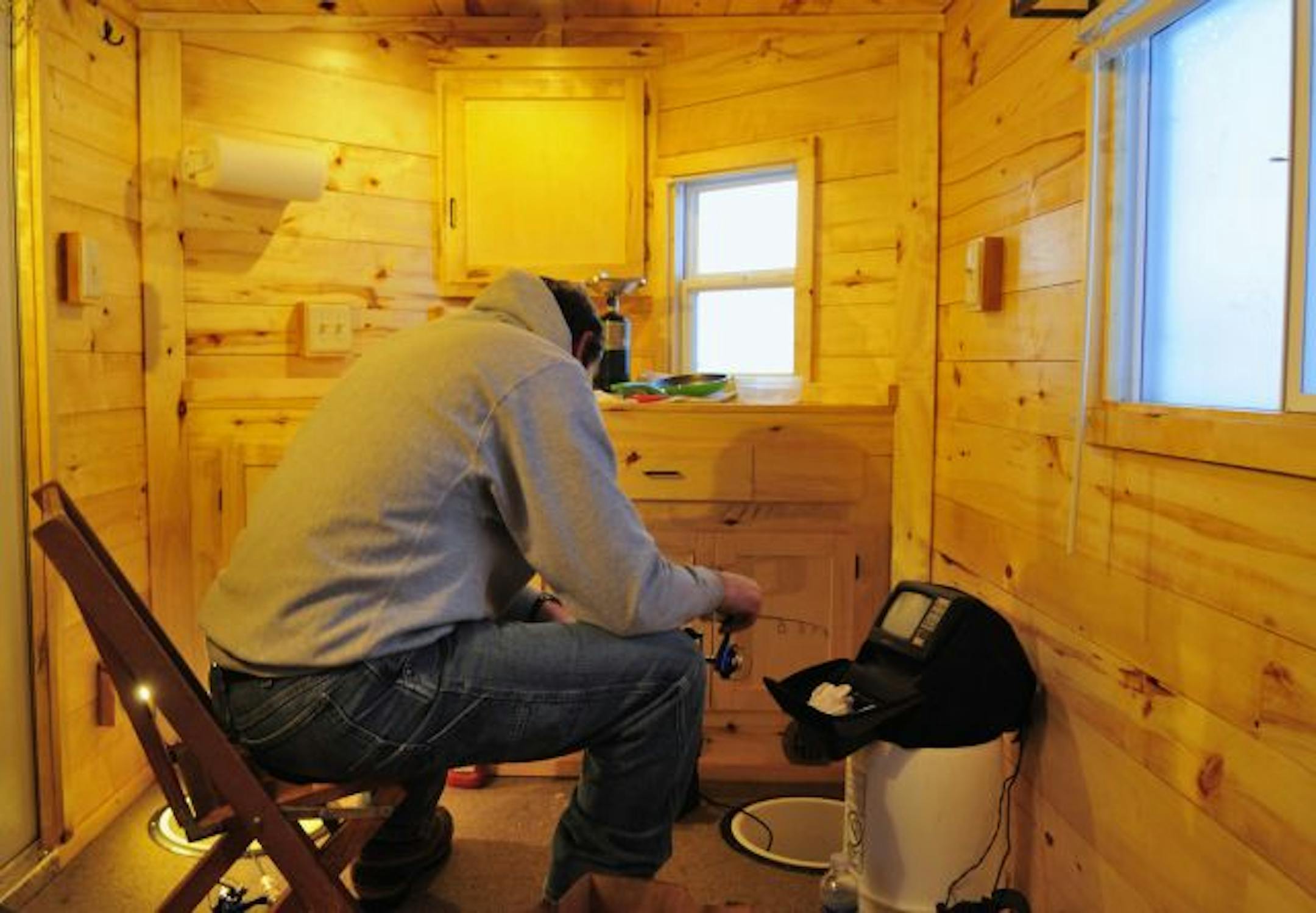 Lindy Frasl jigged for walleys in his home-built fish house on wheels. The fancy shelter affords all the comforts of home.