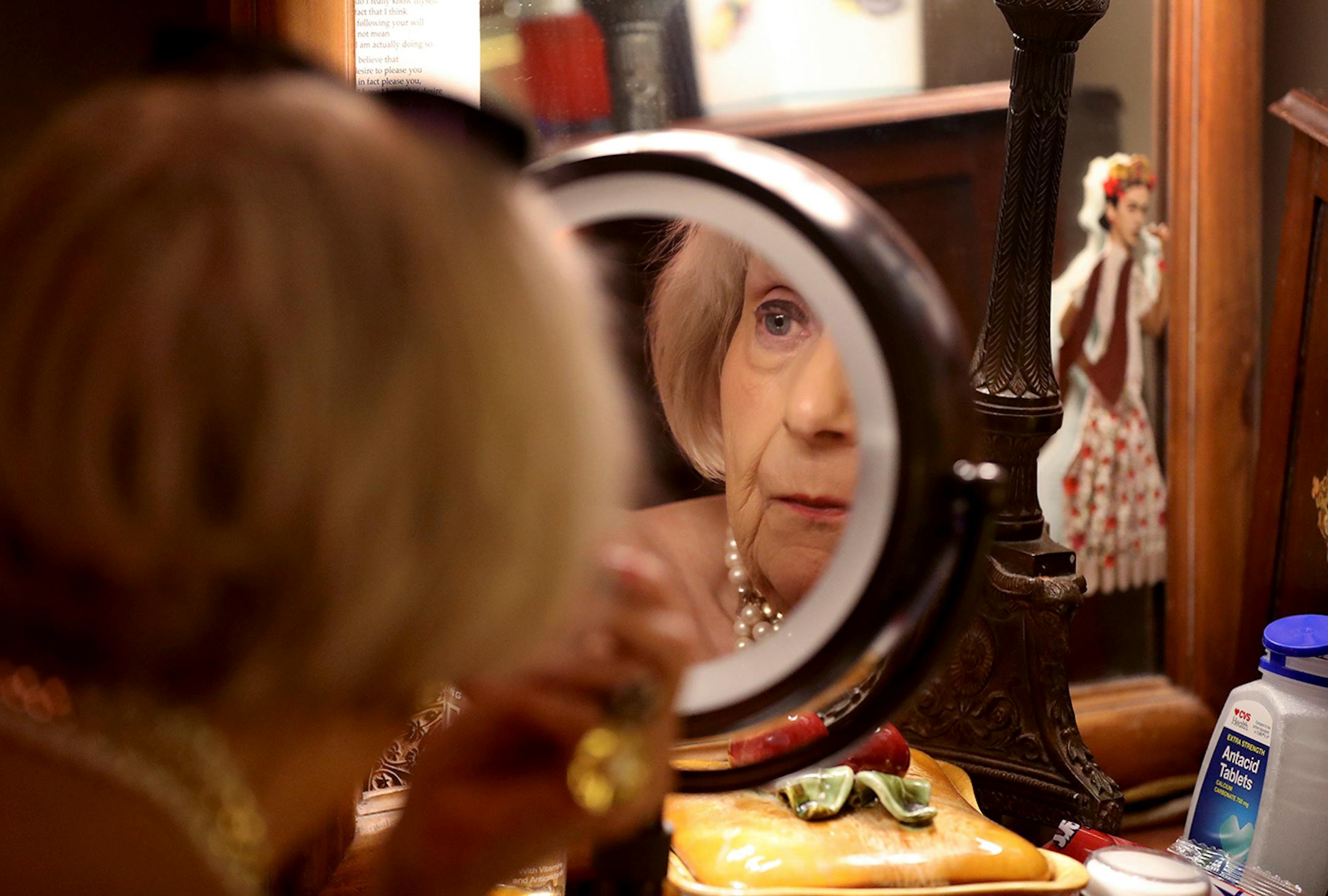 Barbara Carlson applies makeup.