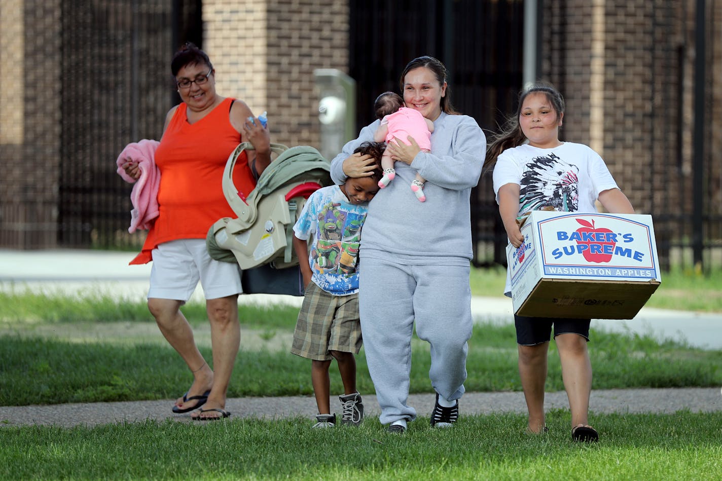 Raejean Icard, center in gray, is reunited with her family after being released from Shakopee women's prison in June. From left is her mother Ida Icard, son Evan, 8, two-month-old daughter Eniya and daughter Ebony, 11. Icard gave birth to Eniya while incarcerated.