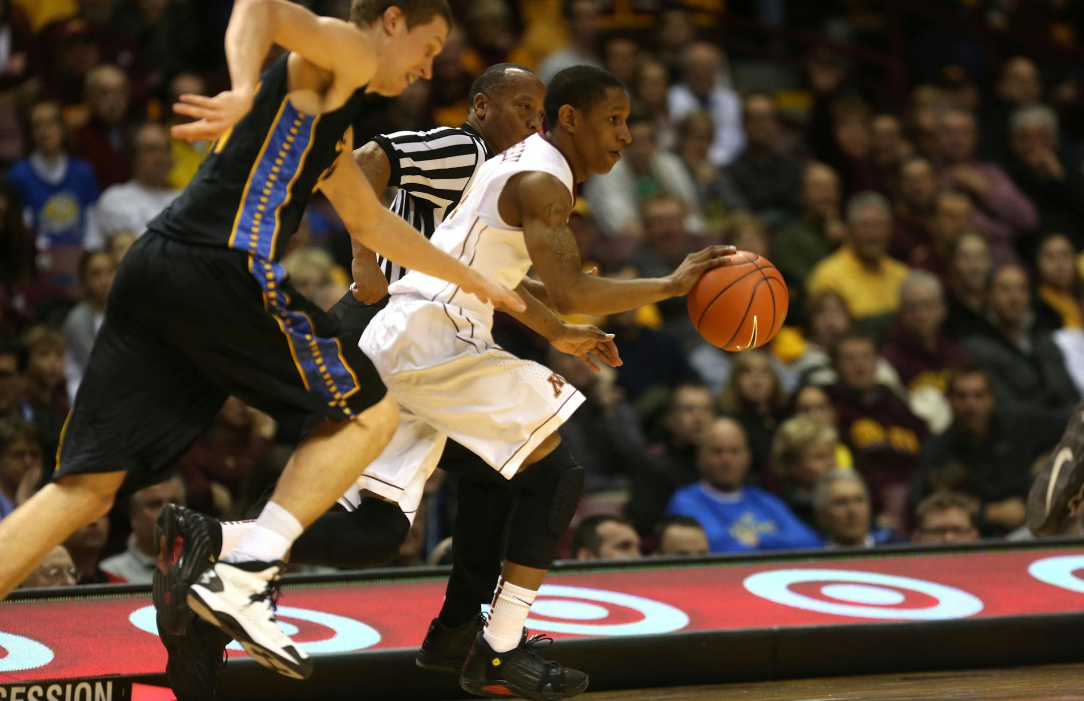 Gopher DeAndre Mathieu raced up the court passed South Dakota State's defenders during the first half at Williams Arena in Minneapolis Tuesday, December 10, 2013.