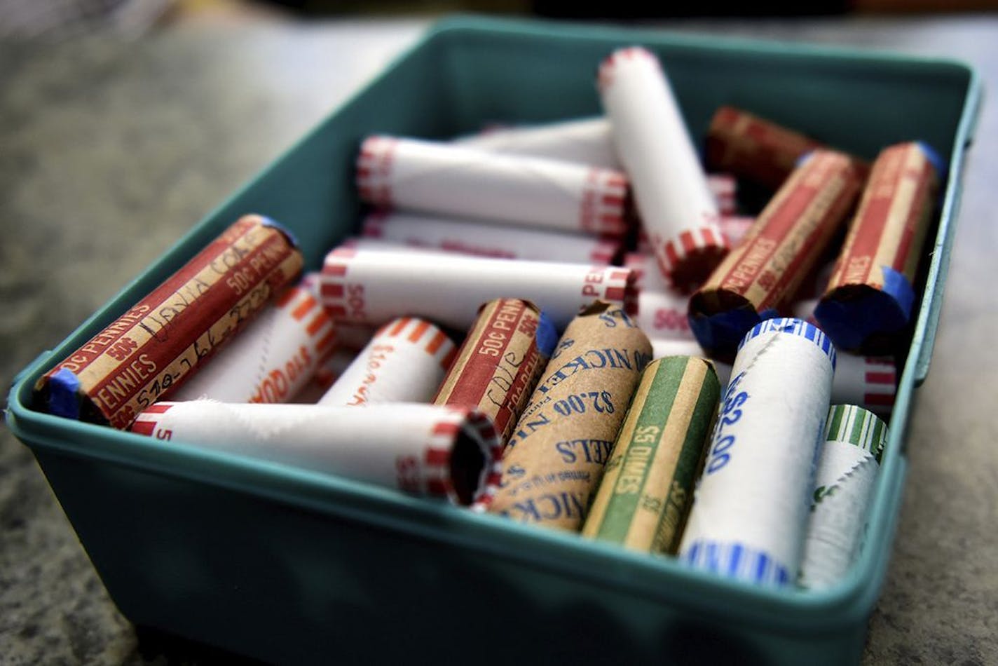 FILE - This Wednesday, July 15, 2020 file photo shows rolls of coins in a container at a market in Nanticoke, Pa. Stories circulating online incorrectly deny the existence of a coin shortage in the U.S. The shortage is real, says The Federal Reserve, which manages the country's coin inventory. Coins aren't being circulated because businesses are closed and sales are down during the pandemic.