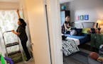 Volunteers from Humble Design Irais Ibarra, left, and Kim Hannay put finishing touches at a bathroom and bedroom of Sheronna Ragin-Winters, 38, during
