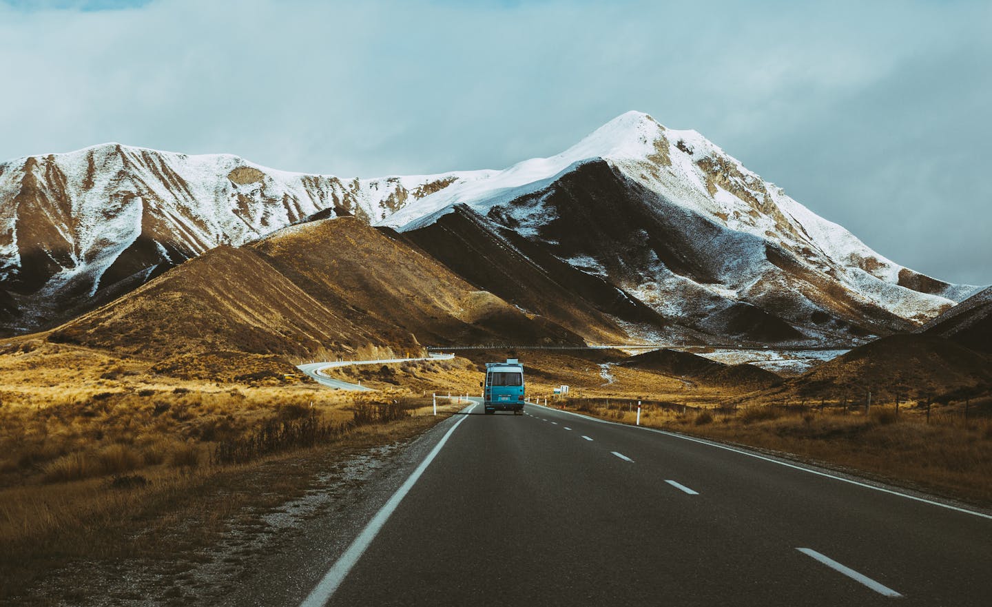 A camper van traversed mountains and plains en route from Mount Cook to Wanaka, New Zealand.