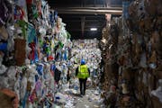 Miriam Holsinger, co-president of Eureka Recycling, walks between bales of recycled materials to examine bales of trash that was sorted out Tuesday, J