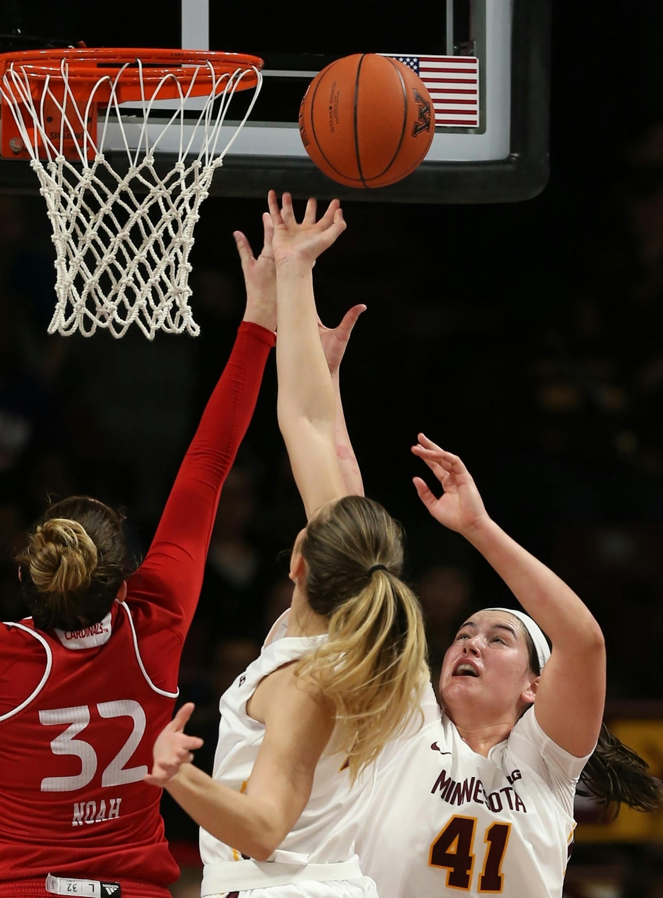 Annalese Lemke(41) of Gophers goes for rebound.