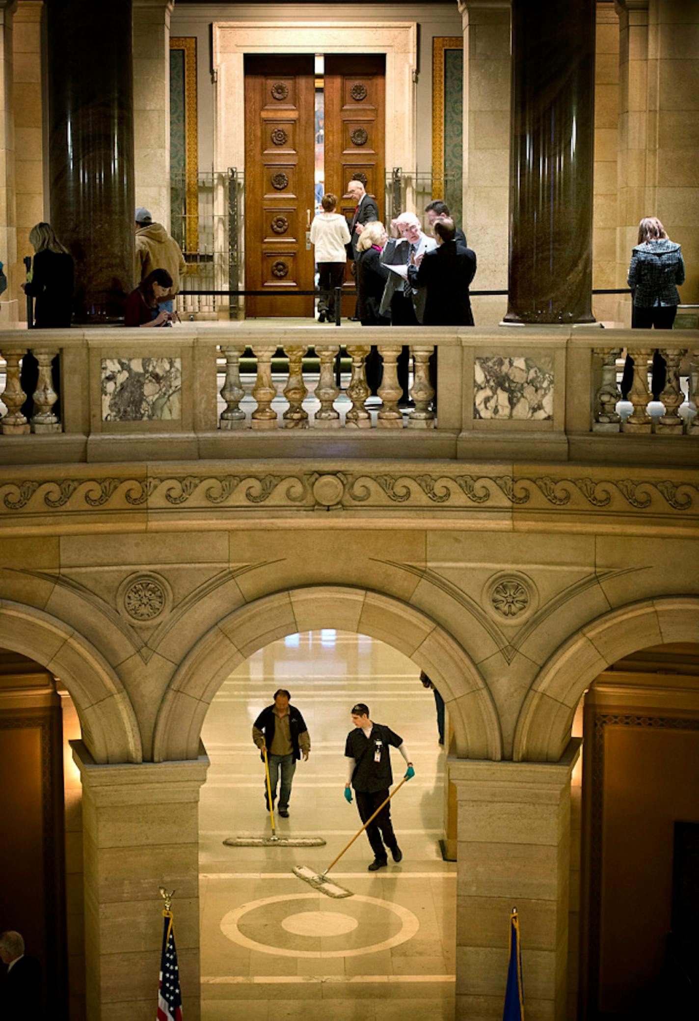 Lobbyists line the hallways outside the House chamber and custodians sweep the floors as the Minnesota House debates the health insurance exchange into the evening, Monday, March 4, 2013.   ]   GLEN STUBBE * gstubbe@startribune.com