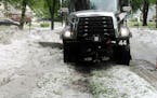 A Coon Rapids snow plow clears away hail from a June storm that battered the metro and left behind more than $600,000 in damage to Anoka County public