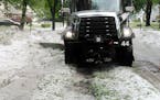 A Coon Rapids snow plow clears away hail from a June storm that battered the metro and left behind more than $600,000 in damage to Anoka County public