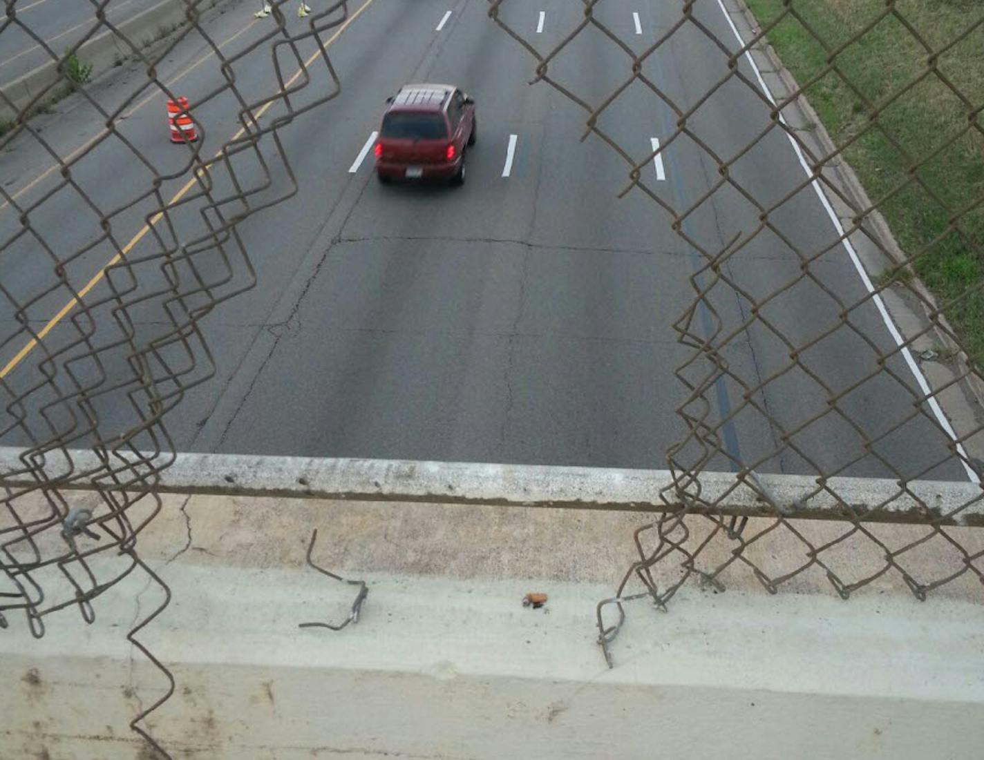 A hole in the fence on the Dale Street bridge over I-94 in St. Paul, where passersby helped police pull a suicidal woman to safety.