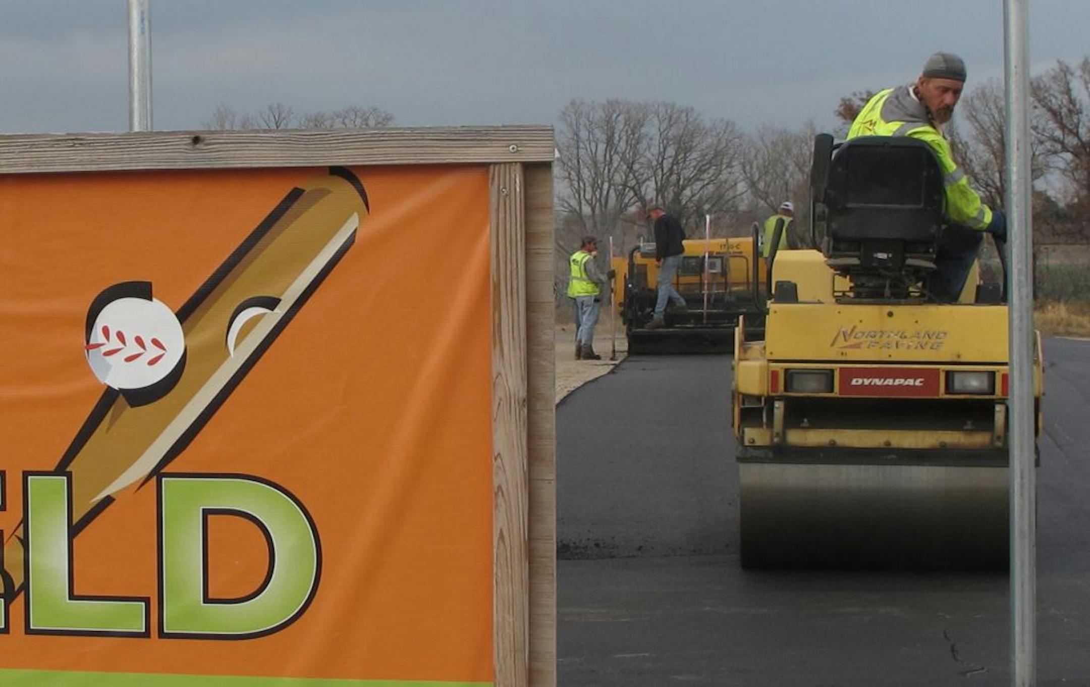 Photo by Kevin GilesTom Egilsson of Jordan, Minn., smoothes hot asphalt at Woodbury�s Miracle Field this past week. His company, Northland Paving of Lakeville, also paved the Miracle Field in that city. Cutline: Tom Egilsson of Jordan, Minn., smoothes hot asphalt at Woodbury�s Miracle Field this past week. His company, Northland Paving of Lakeville, also paved the Miracle Field in that city.