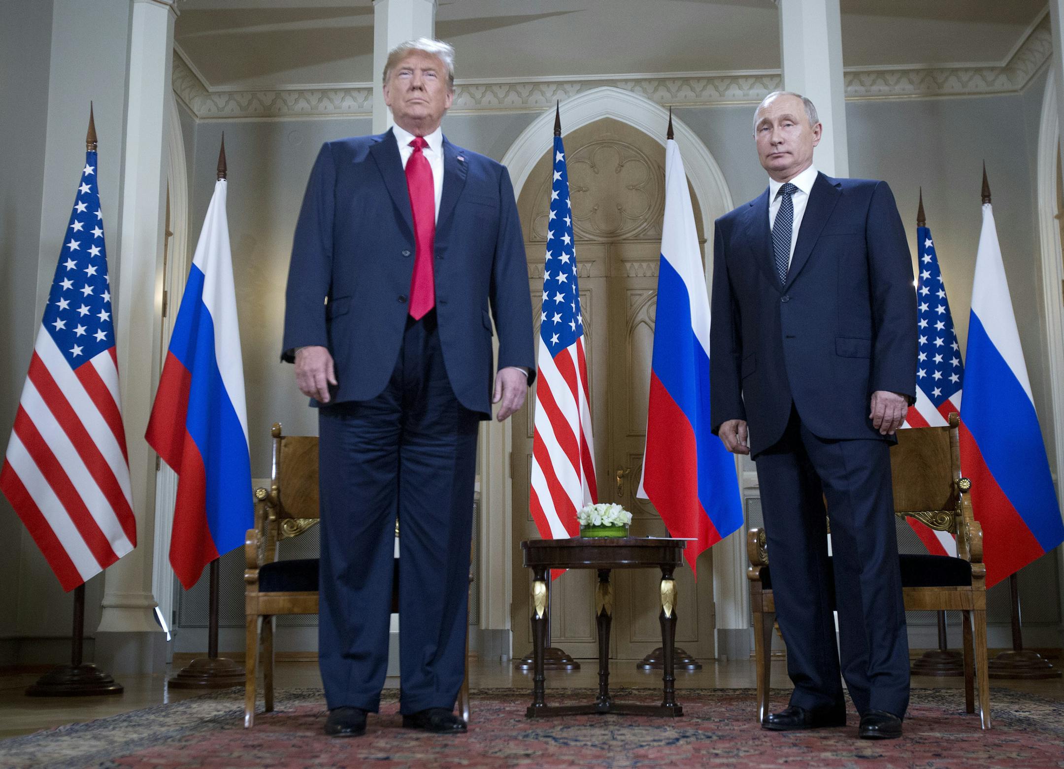 U.S. President Donald Trump, left, and Russian President Vladimir Putin, right, arrive for a one-on-one meeting at the Presidential Palace in Helsinki, Finland, Monday, July 16, 2018. (AP Photo/Pablo Martinez Monsivais)