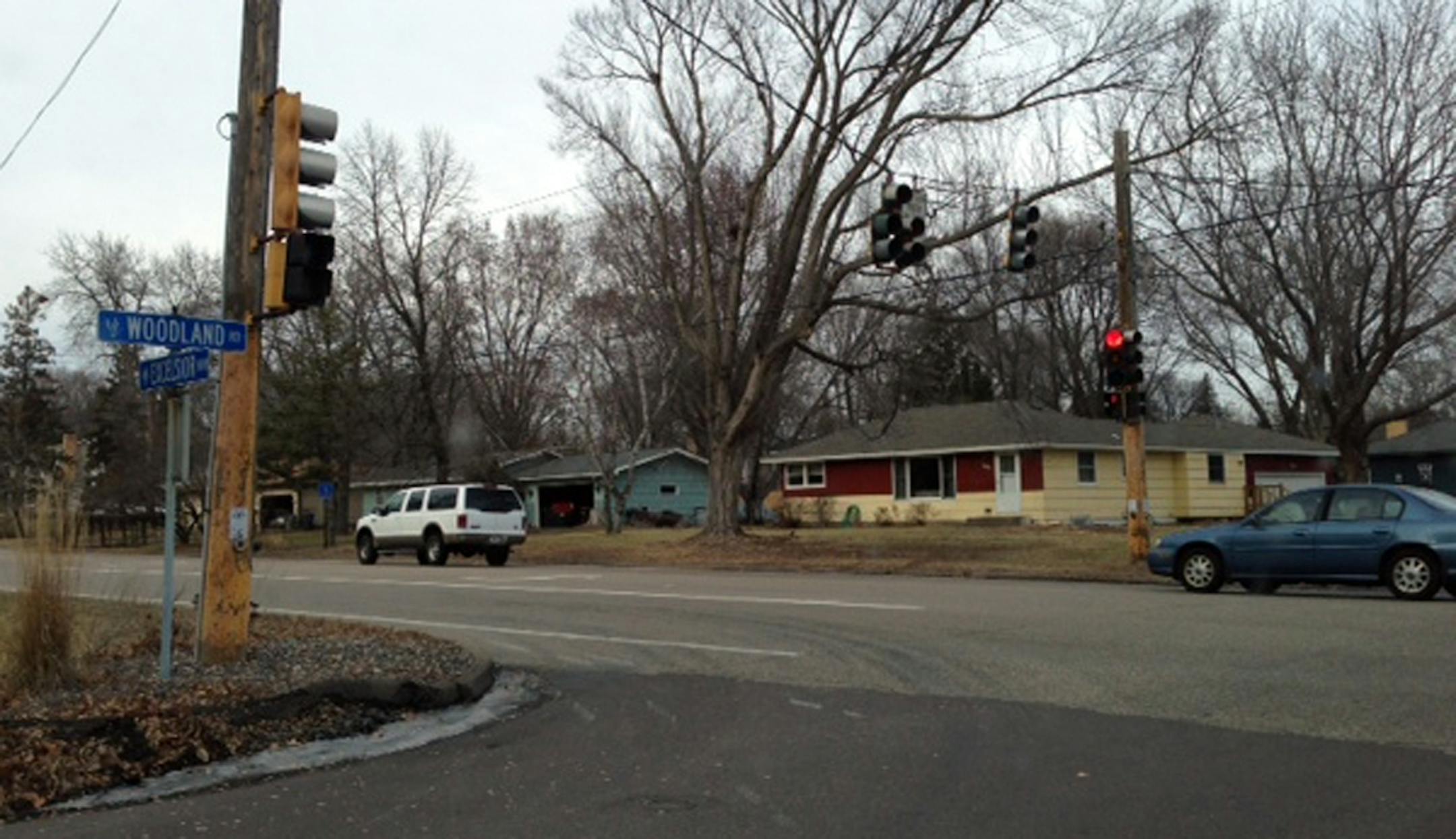 photos from my phone of the intersection and the damage to Barbara Yasger's home off Excelsior Boulevard and Woodland Road, which was hit by the black BMW driven by Sean Kian. There were black tire marks throughout the lawn from the car, which came to a stop right at the corner of her home. Kelly Smith