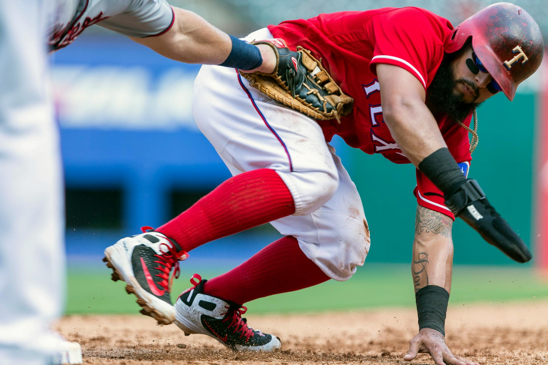 Texas Rangers' Rougned Odor is tagged out by Minnesota Twins first baseman Chris Gimenez during the third inning of a baseball game Sunday, Sept. 2, 2018, in Arlington, Texas. (AP Photo/Sam Hodde)