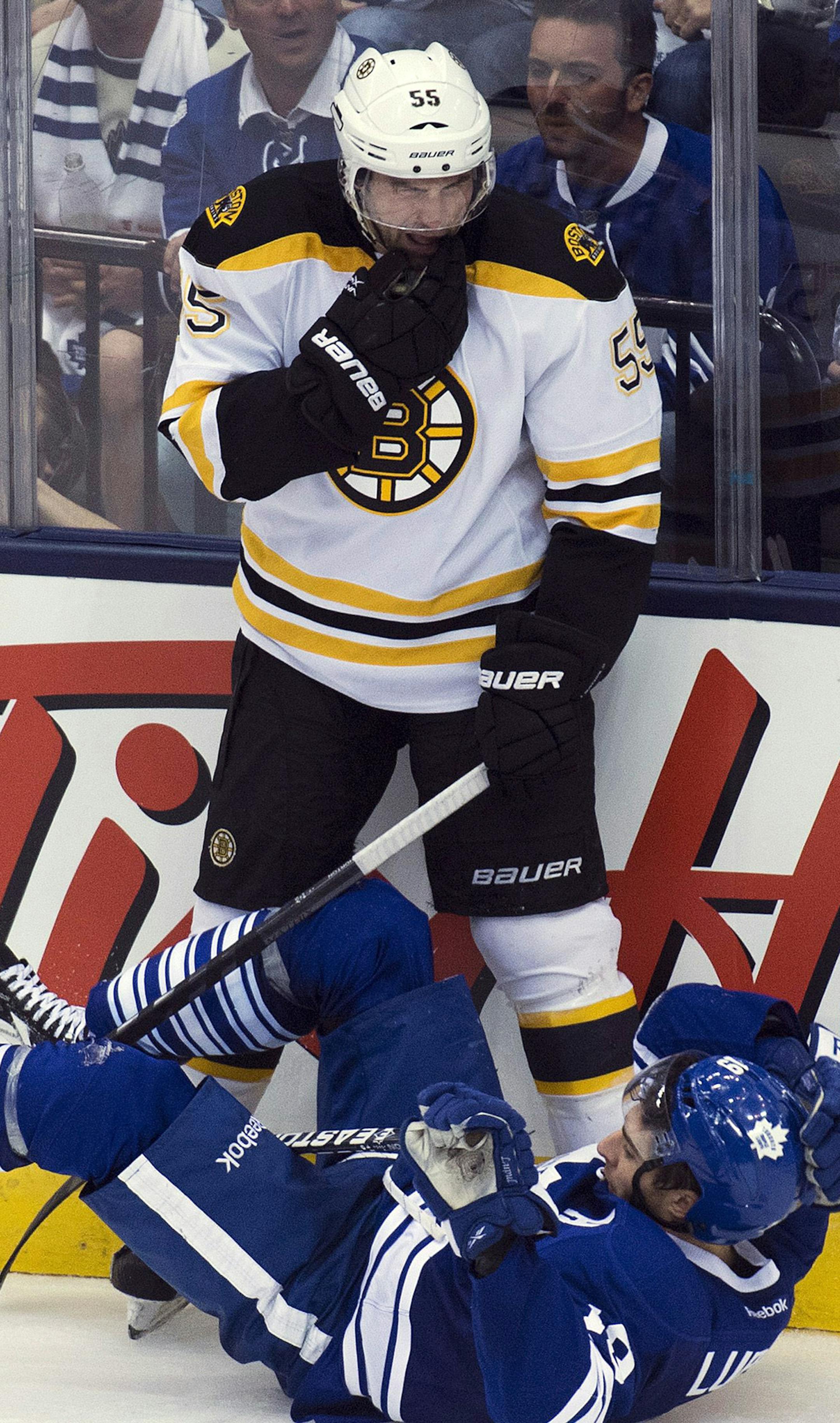 Toronto Maple Leafs forward Joffrey Lupul, bottom, lays on the ice as Boston Bruins defenseman Johnny Boychuck, top, looks on during the second period of Game 3 of their first-round NHL hockey Stanley Cup playoff series, Monday, May 6, 2013, in Toronto. (AP Photo/The Canadian Press, Nathan Denette) ORG XMIT: MIN2013061120284790