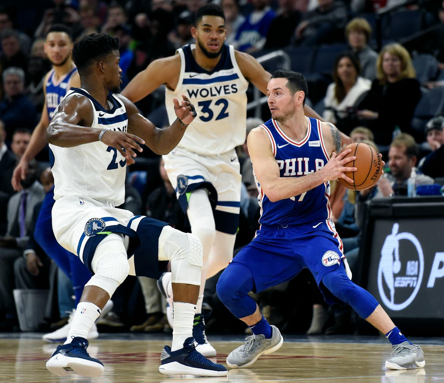 Minnesota Timberwolves guard Jimmy Butler (23) and center Karl-Anthony Towns (32) guard Philadelphia 76ers forward JJ Redick (17) during overtime on Dec. 12, 2017.