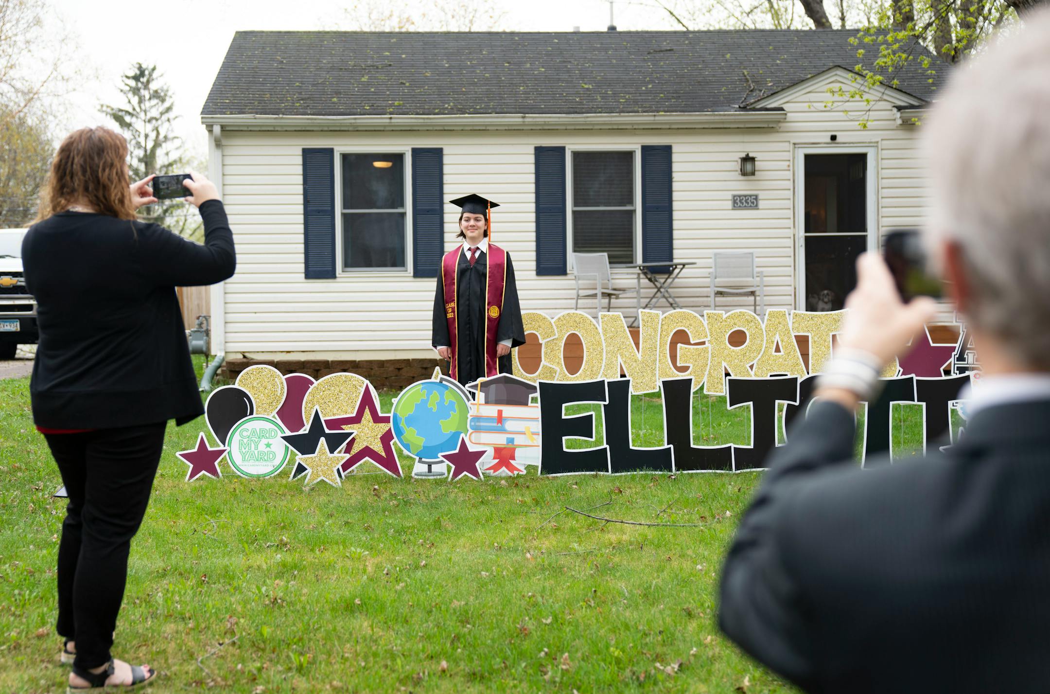 Michelle and Patrik Tanner take photos of their son, Elliott, 13, before his graduation.
