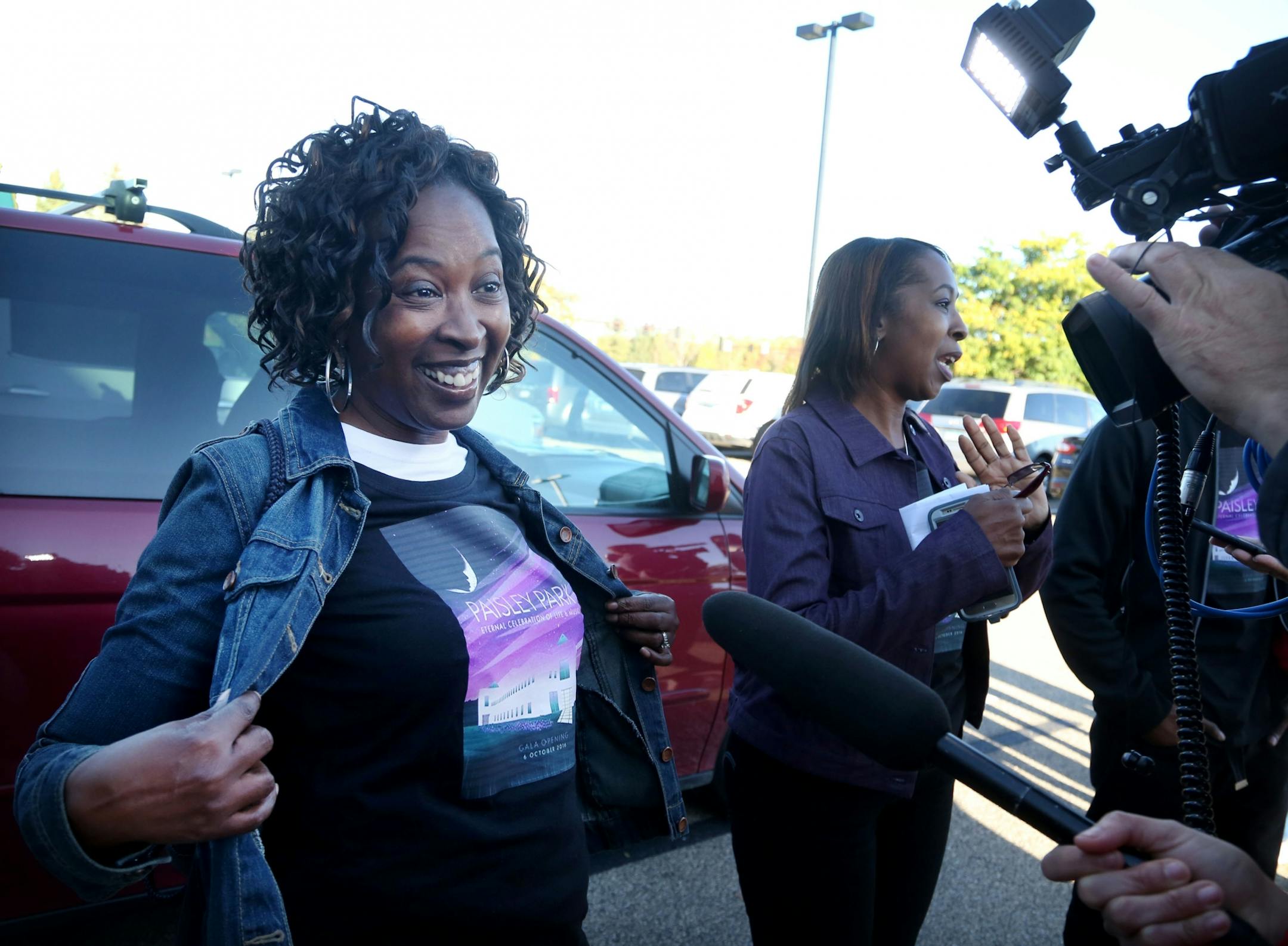 Prince fan Gloria Brown of Chicago shows off her custom made Paisley Park t-shirt as she waited to get inside with her sister Yvonne Brown, right, and nephew Chris Brown, not pictured. They were among the first Paisley Park tour ticket holders to get inside Paisley for the new Paisley Park Tour Thursday, Oct. 6, 2016, in Chanhassen, MN.