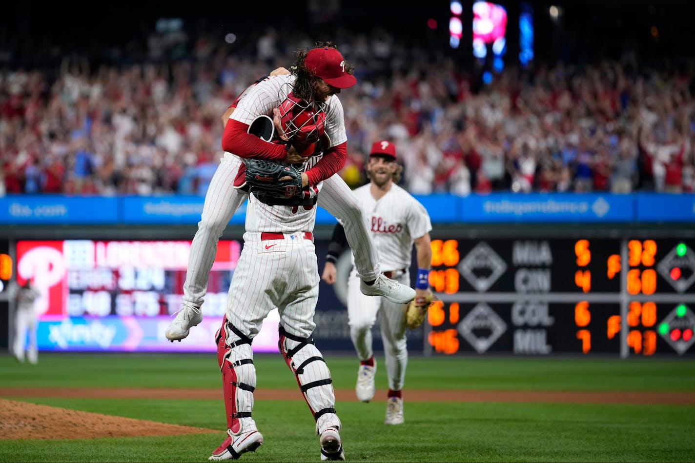 Philadelphia Phillies pitcher Michael Lorenzen, left, and J.T. Realmuto celebrate after Lorenzen's no-hitter during a baseball game against the Washington Nationals, Wednesday, Aug. 9, 2023, in Philadelphia. (AP Photo/Matt Slocum)