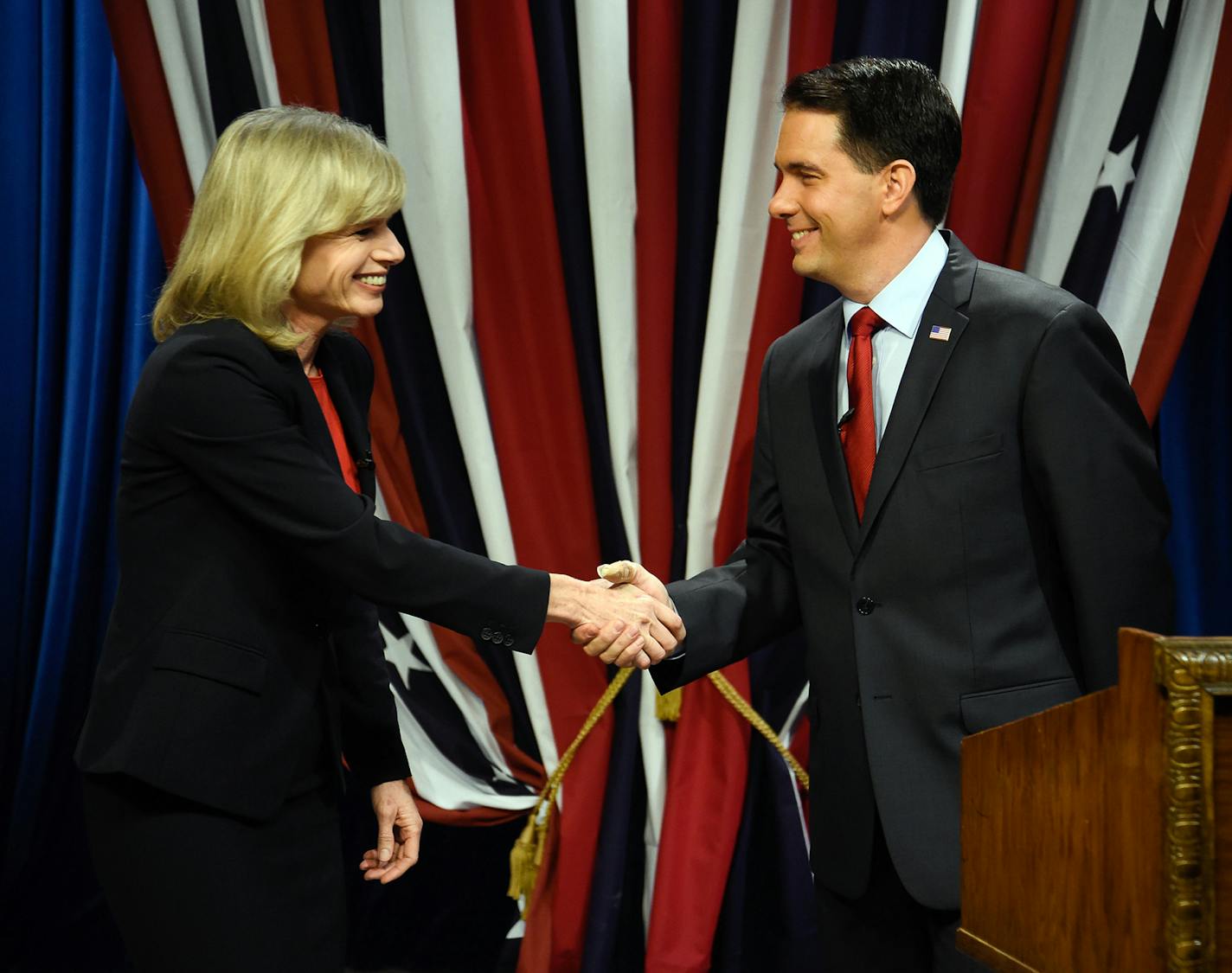 Wisconsin Republican Governor Scott Walker, right, shakes hands with Democratic challenger Mary Burke before a televised debate Friday, Oct. 17, 2014, at the WMVS-TV studio in Milwaukee. (AP Photo/Benny Sieu) ORG XMIT: MIN2014102414034355