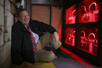 Richard Murphy with batteries that are the backup power supply for the computer system at a Murphy Warehouse Co. facility in Minneapolis Monday aftern