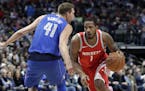 Dallas Mavericks forward Dirk Nowitzki (41) of Germany defends as Houston Rockets forward Trevor Ariza (1) drives to the basket in the first half of a