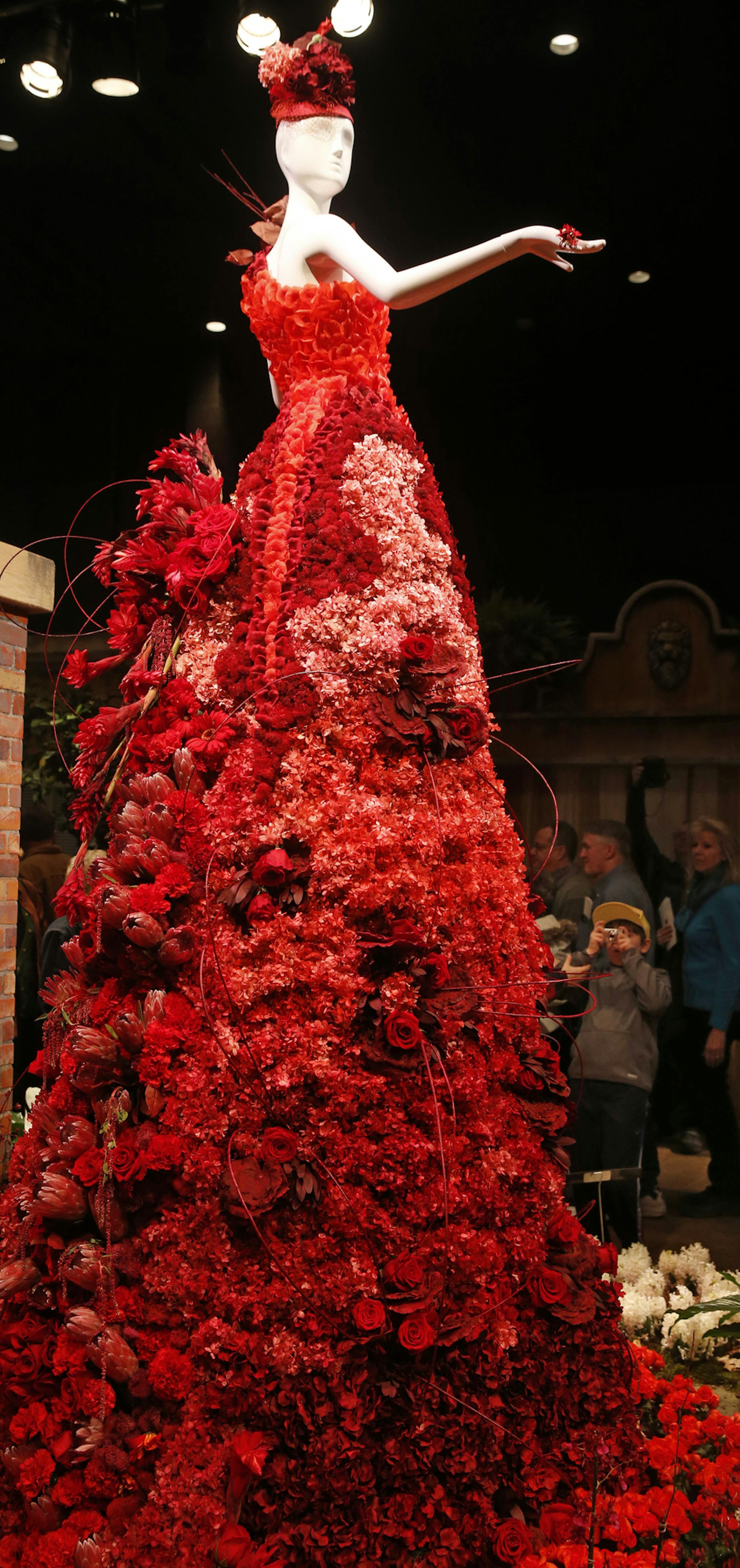 At the opening day of the annual Macy’s Flower Show, “The Secret Garden,” hundreds of people were waiting for the doors to open before the opening at noon. It took 3000 hours to create the display including this gown of mostly live flowers.