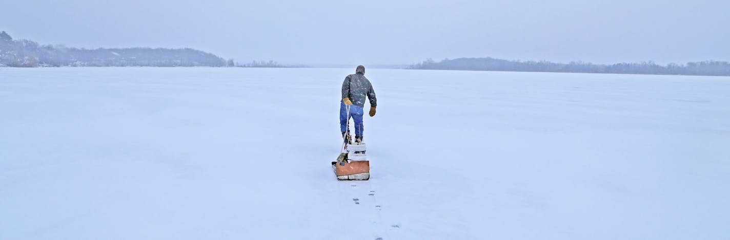 Dick "Griz'' Grzywinski of St. Paul pulled a sled full of fishing gear onto Chisago Lake last week, where between 5 and 7 inches of ice was found.