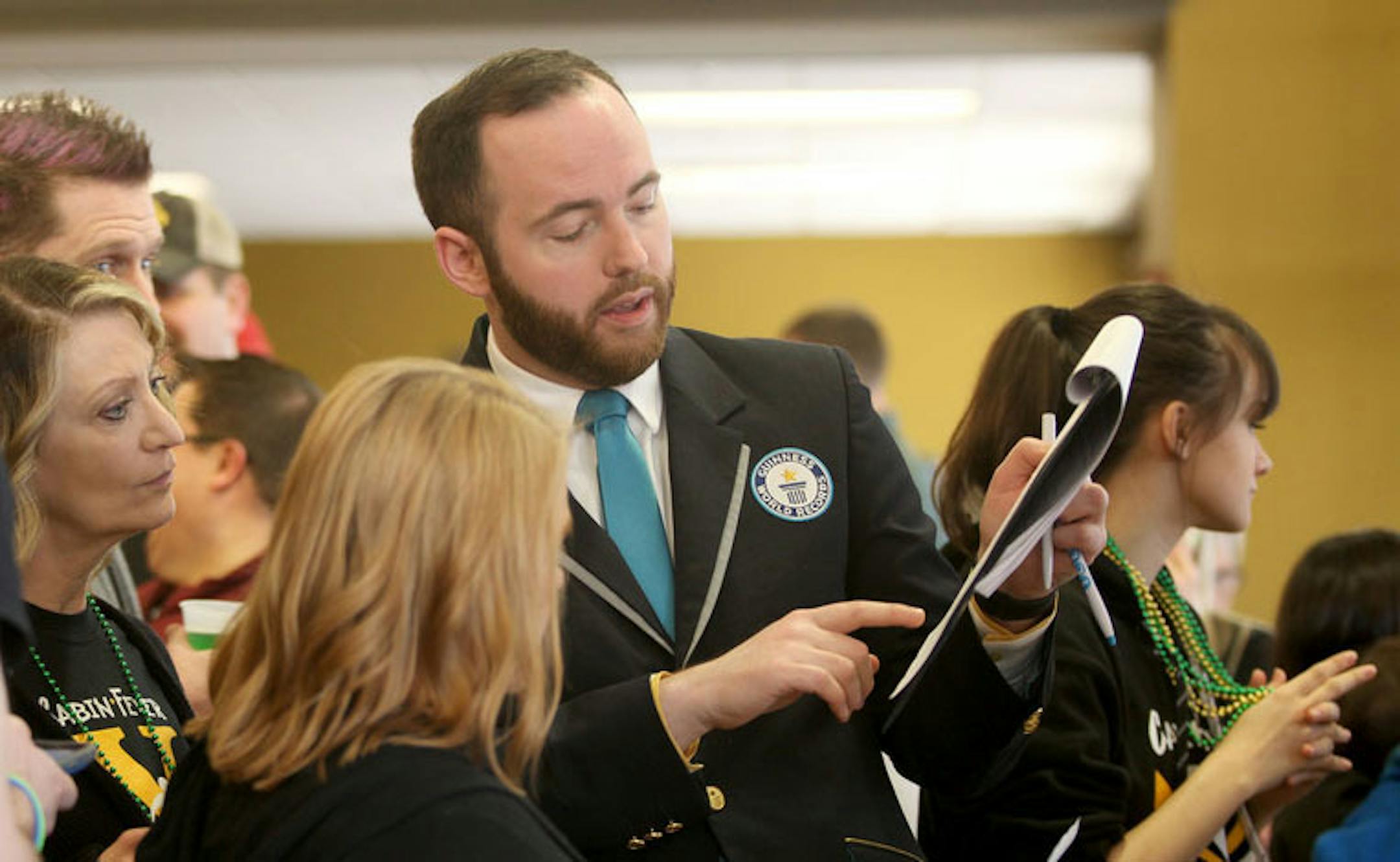 Adjudicator Mike Marcotte, of Minneapolis, MN, center, consults with a team of judges before his announcement at the annual Cabin Fever Bean Bag Tournament that a Guinness World Record was set as the largest cornhole tournament Saturday, March 16, 2019 at the Rochester International Event Center in Rochester, MN. More than 380 participated and raised funds supporting cancer research. "There are less than 100 of us in the world, it's a pretty cool job," said Marcotte, who is the only adjudicator