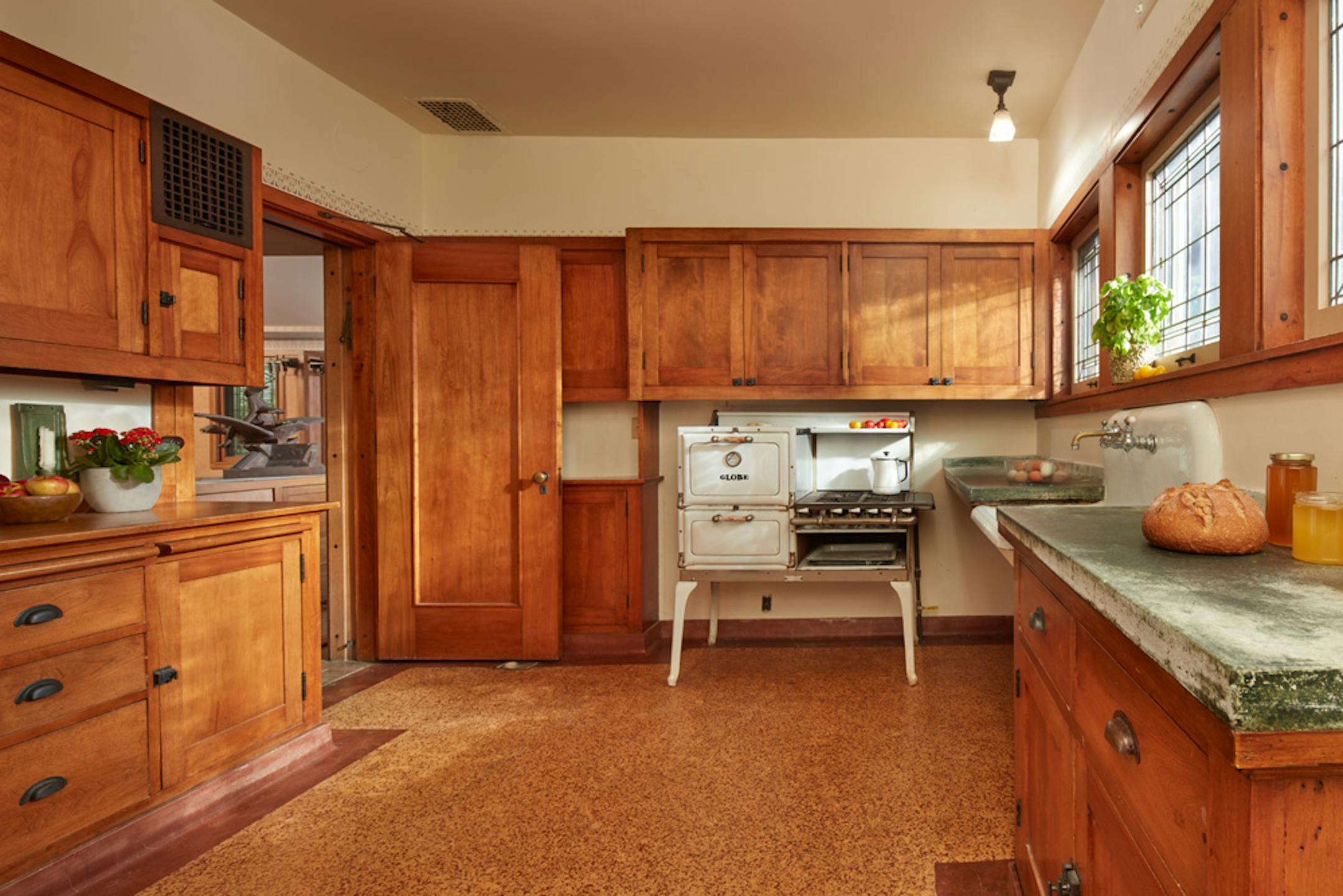 Purcell-Cutts House, 2328 Lake Place, Minneapolis, Minnesota, 1913, William Gray Purcell, Architect.George Elmslie, George Feick Jr. partners in firm Purcell, Feick and Elmslie, Edna S. Purcell House, Prarie School Style, Open floor plan, Art Glass windows, Writing Nook, Fireplace wall Mural by Charles Livingston Bull, Louisana Herons Flying with two Moons, Iridescent glass mortered in frieplace base, Stencil pattern, Peak a Book stained glass entry, Grandfather Gray portrait by Lawton Parker in Entrance Hall, Dining room Art Glass double door to screend-in Porch, Reflecting Pool and landscape designed by Harry Franklin Baker, Living room, Stair Hall, Master Suite, Sleeping Porch, Built in cedar floor storage, fireplace, childrens room connected to master with accordian style operating partition, sunken Living room,tent Ceilings, Ceiling Lights and art glass by Mosaic Art Shops Minneapolis, Maid Call Button, Air conditioning, Central vacuum system, sliding kitchen door operated by foot button, icebox in kitchen with door to outside, custom Sitting chair, Custom Floor lamp, Custom Dining room table,chairs and sideboard, Custom Cluster Pendant lighting, Oak hardwood floors and trim, Custom Throw rugs, Continuous tented roof and ceiling, Elevated dining room, dropped floor living room, "Little Joker", Personalized home with monogram ESP for Edna S. Purcell,