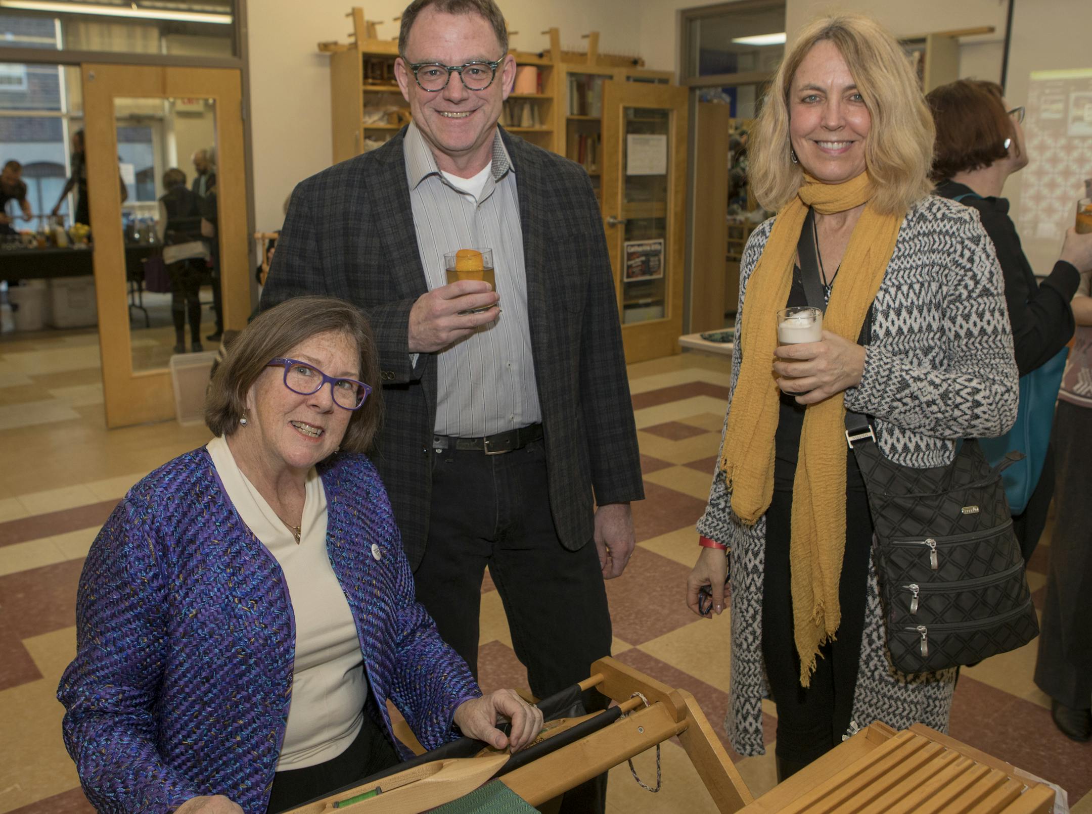 Karen Mallin shows Kevin Olsen and Anne Hammond her floor loom at Cocktails by Design. [ Special to Star Tribune, photo by Matt Blewett, Matte B Photography, matt@mattebphoto.com, Goldstein Museum of Design, Cocktails by Design, March 22, 2018, Minnesota, SAXO 1005784328 FACE040118
