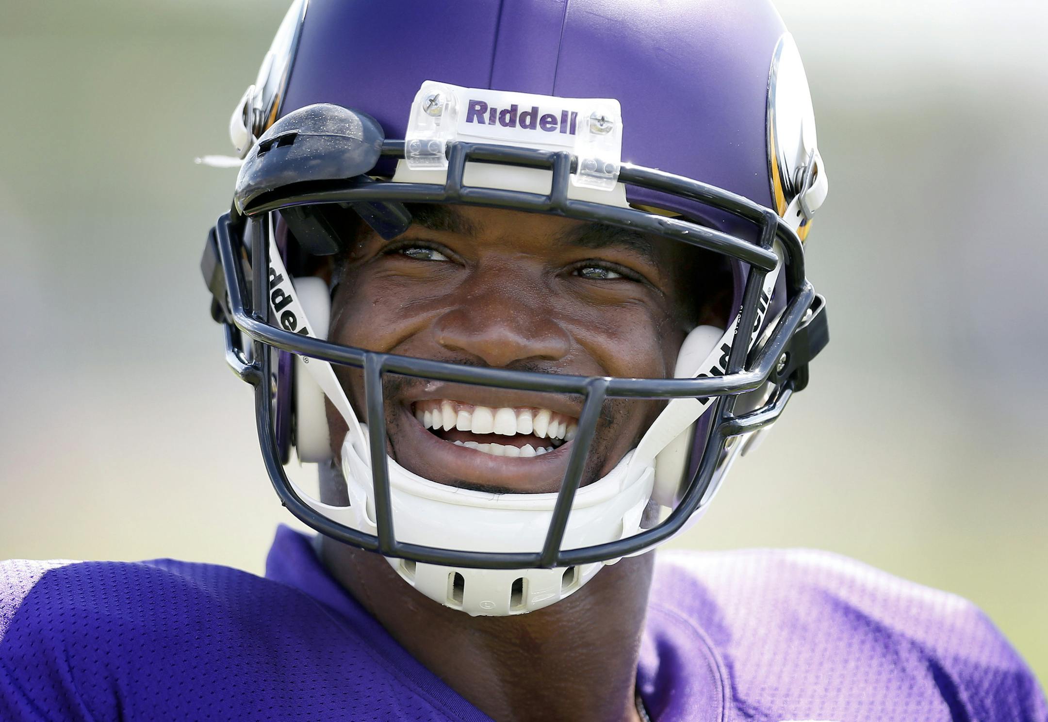 Minnesota Vikings running back Adrian Peterson (28) cracked a smile after hearing his name repeatedly called by a young fan in the stands during practice on Wednesday. ] CARLOS GONZALEZ cgonzalez@startribune.com July 31, 2013, Minnesota Vikings Training Camp, Mankato, Minn., Minnesota State University, Mankato - afternoon practice ORG XMIT: MIN1307311810484843