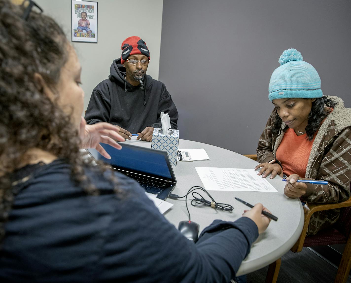 Anthony Moris, left, and Jasmine Young, right, signed up for housing with Next Step Housing Assessor Stephanie Martin at St. Stephen&#x2019;s Human Services, Thursday, November 21, 2019 in Minneapolis, MN. Young, her husband Anthony Moris, and their three children have been homeless since moving to Minnesota three months ago. St. Stephen&#x2019;s Human Services was scored a new $5 million grant from Amazon CEO Jeff Bezos&#x2019; charitable fund to boost help for homeless families in Minneapolis