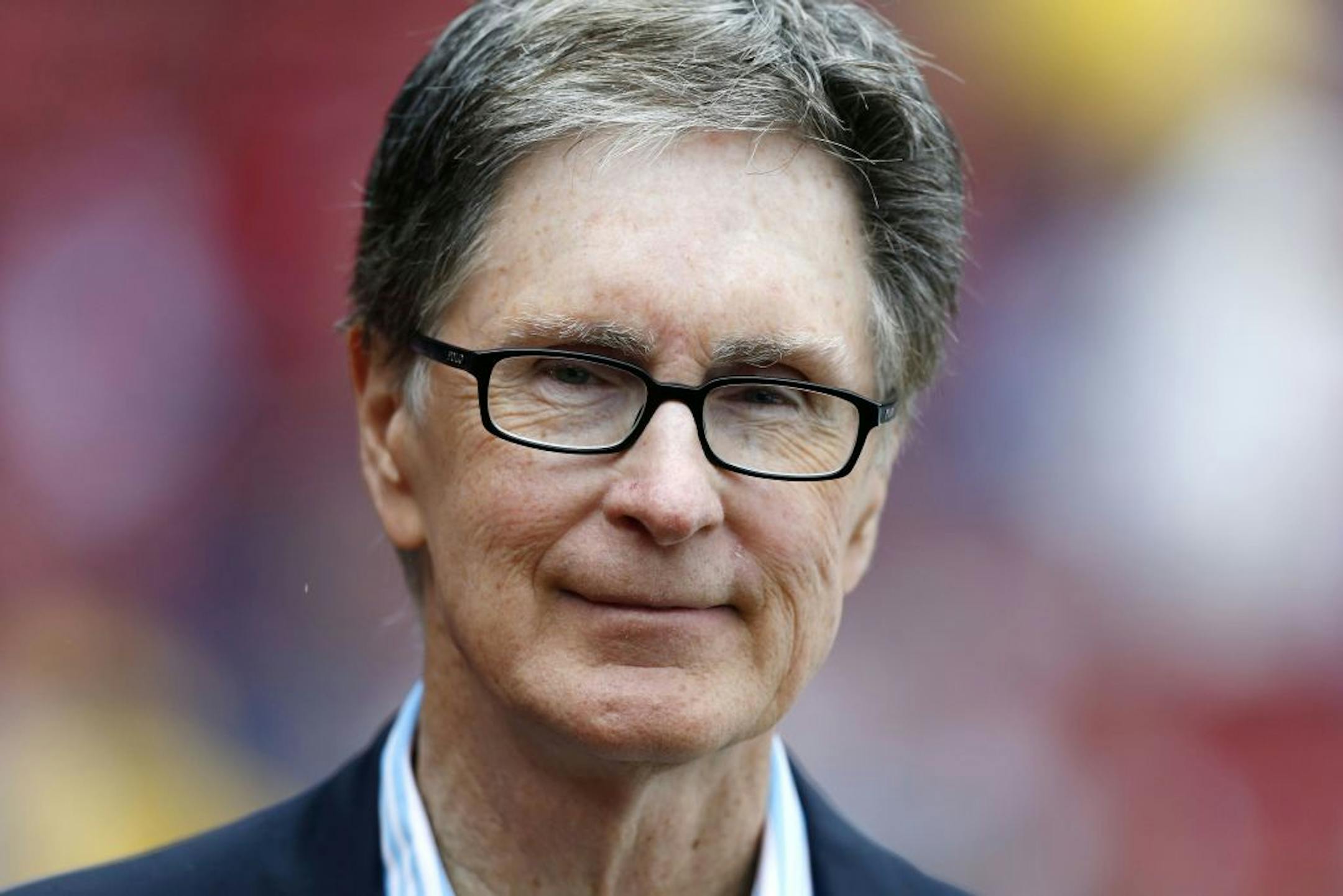 FILE - Boston Red Sox owner John Henry stands on the field before a baseball game in Boston, in this May 11, 2013 file photo. The principal owner of the Boston Red Sox has entered into an agreement to buy The Boston Globe. The Globe says the impending purchase marks businessman John Henry's "first foray into the financially unsettled world of the news media." It said early Saturday Aug. 3, 2013 the deal will give Henry the 141-year-old newspaper, its websites and affiliated companies.