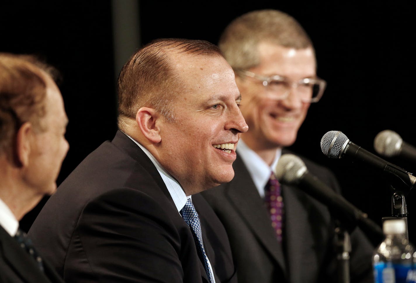 Tom Thibodeau answers a question from the media after he was introduced as the new Minnesota Timberwolves NBA basketball head coach Tuesday, April 26, 2016, in Minneapolis. Listening, left, is Timberwolves owner Glen Taylor, and right, new general manager Scott Layden. (AP Photo/Jim Mone)