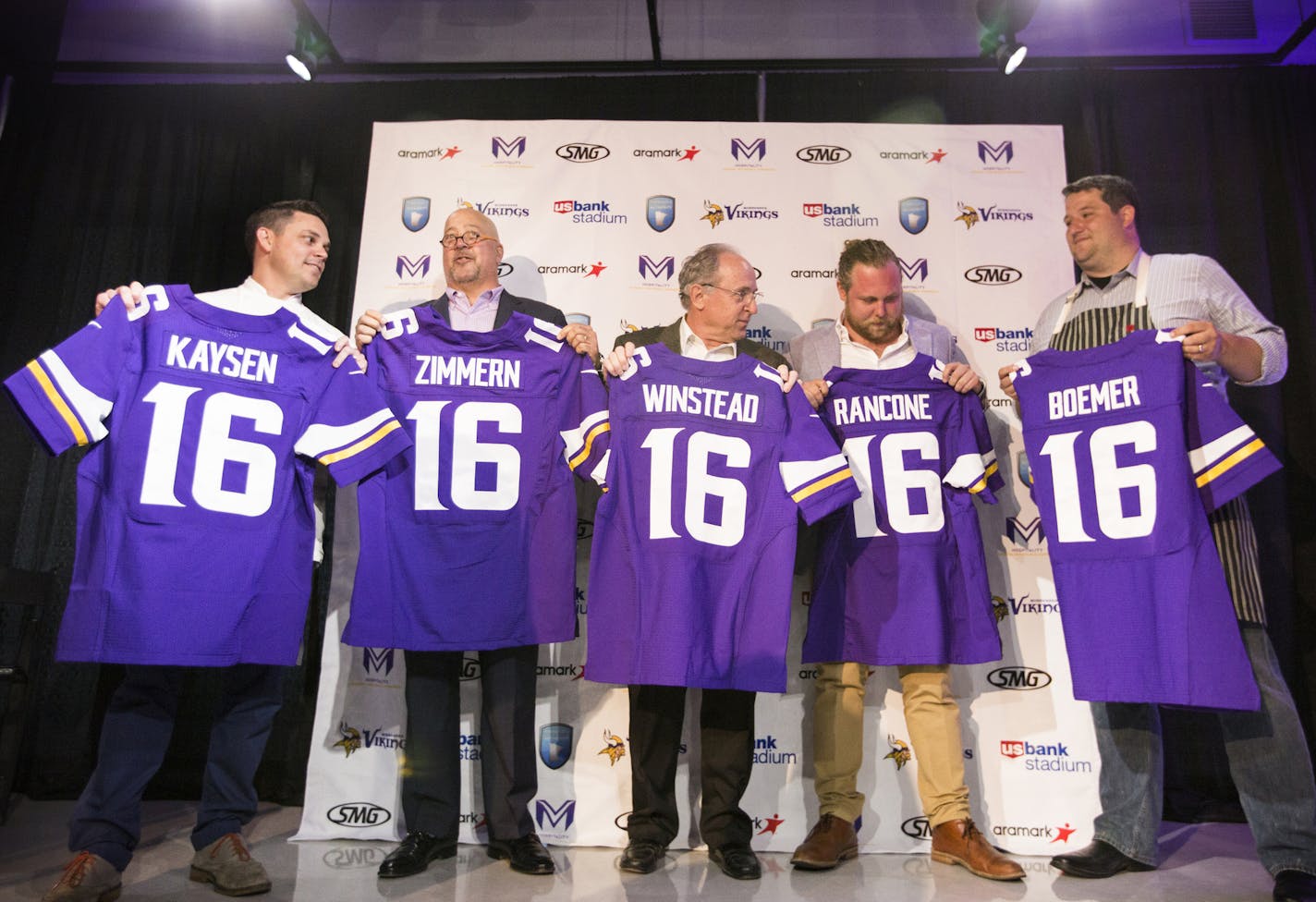 Newly announced U.S. Bank Stadium culinary partners stand for a photo op with their personalized Viking jerseys. From left is Gavin Kaysen, chef and owner of Spoon and Stable, Andrew Zimmern, three-time James Beard award winning chef, Gene Winstead, owner of Ike's Food & Cocktails, and Nick Rancone and Thomas Boemer, co-owners of Revival. ] (Leila Navidi/Star Tribune) leila.navidi@startribune.com BACKGROUND INFORMATION: Officials with the Minnesota Vikings, the Minnesota Sports Facilities Author